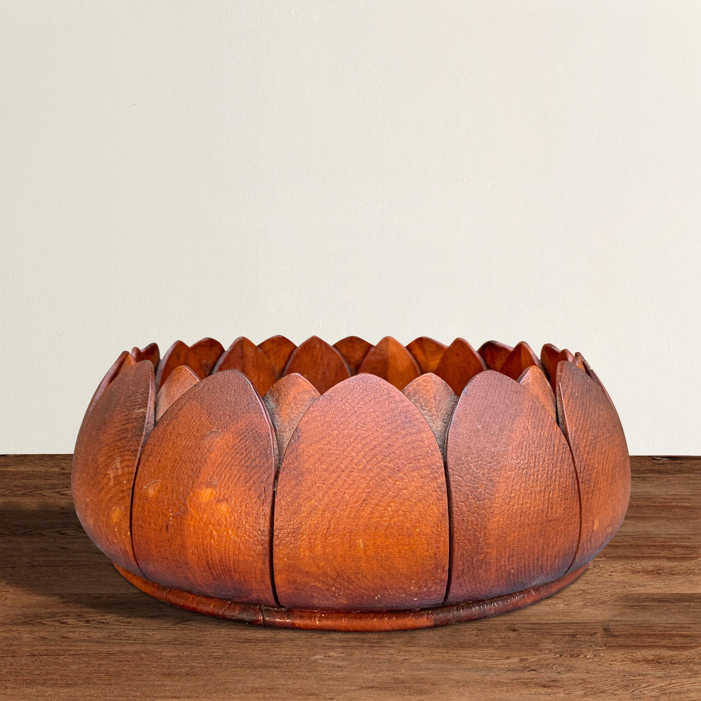 A beautiful late 19th century American pine bowl carved of one piece of wood and with a stylized lotus form. Based on the finish of the wood and the screw holes on the underside, we think this bowl might have been part of the architecture in a