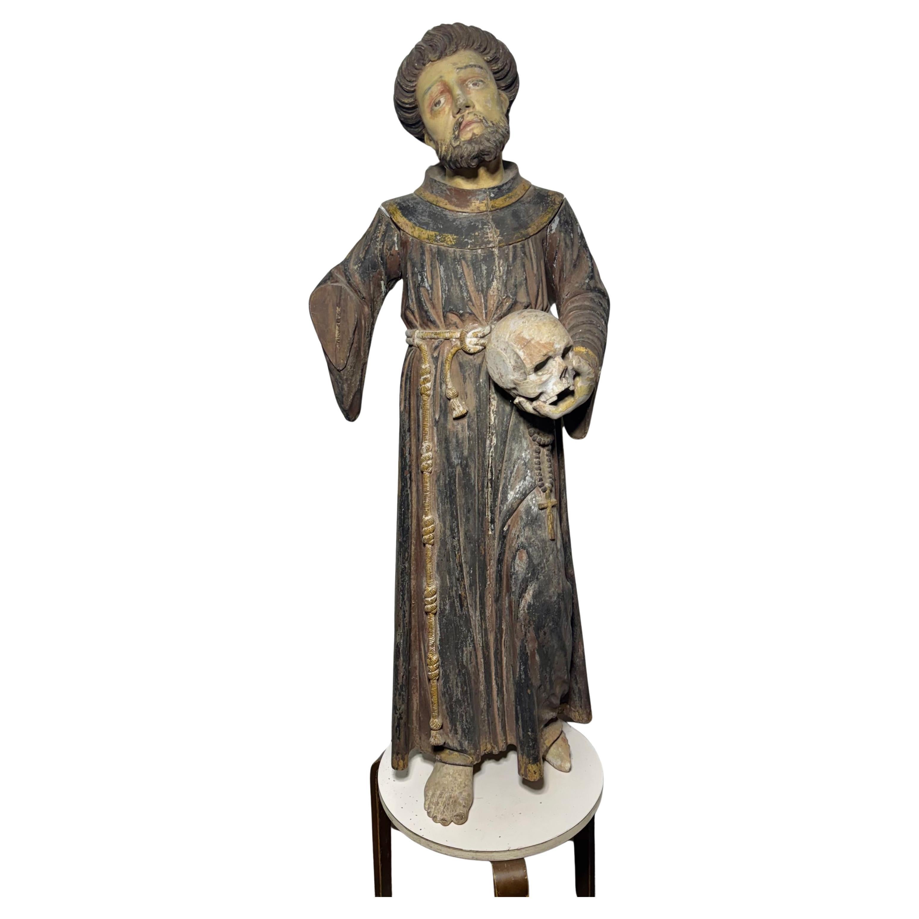 19th Century Carved Wood Religious Statue of a Saint holding skull For Sale