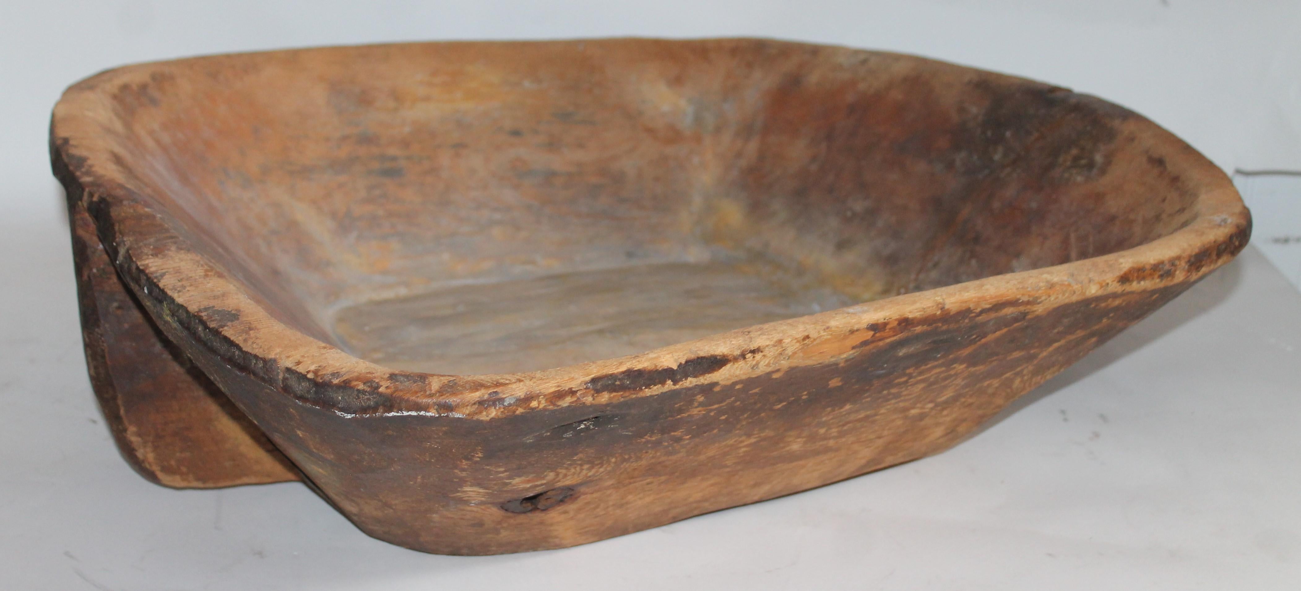 19th century hand carved dough bowl with handles is very primitive with a great surface. The condition is very good and super rustic.