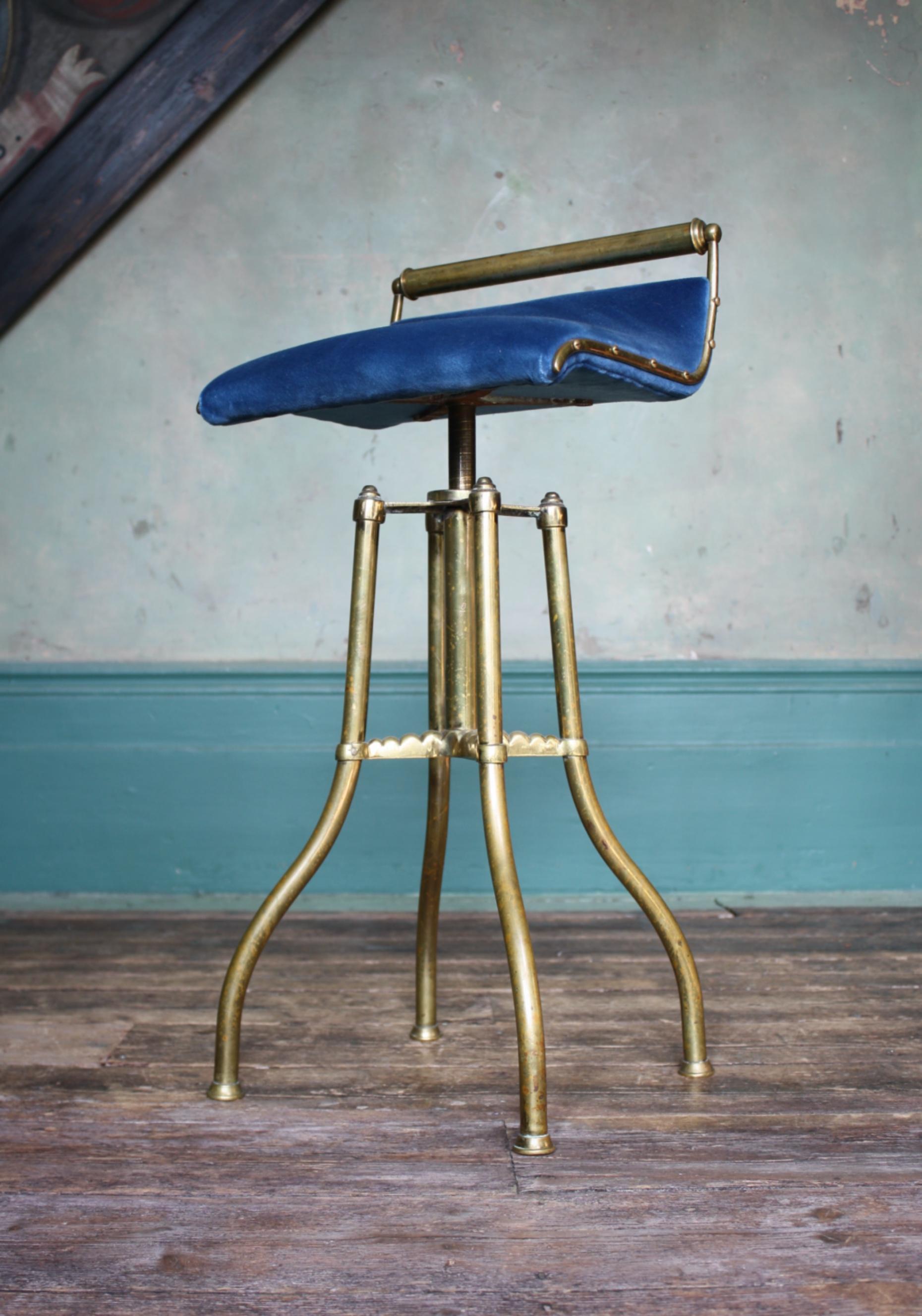 A very good example of a late Victorian music/Cello adjustable stool.

Formed from tubular and cast brass, with a later upholstered royal blue velvet seat. 

The seat adjusts on a large screw system, the brass has age related wear and