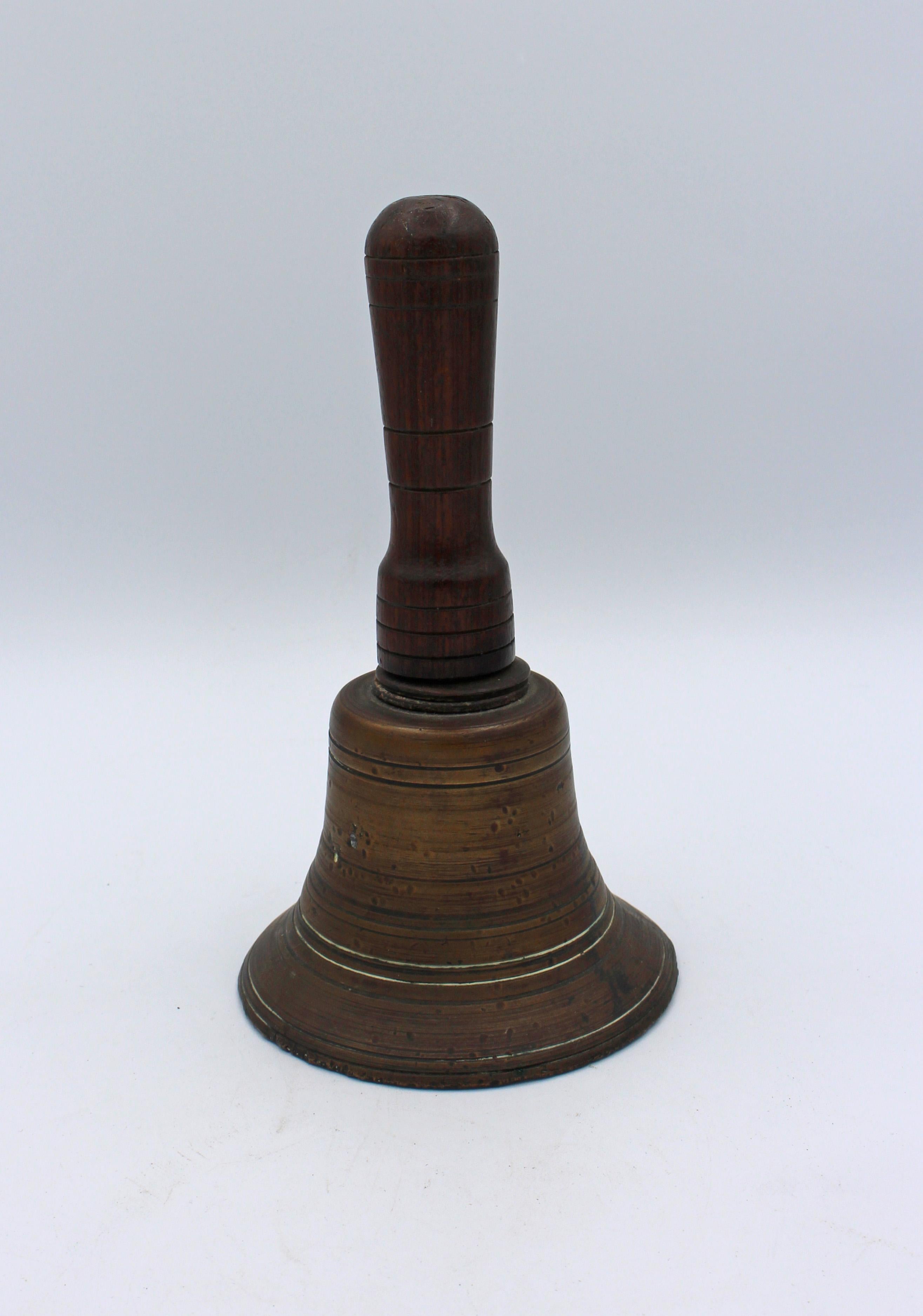 Antique hand bell of cast bronze & turned walnut; mid-late 19th century.
Measures: 4 3/8