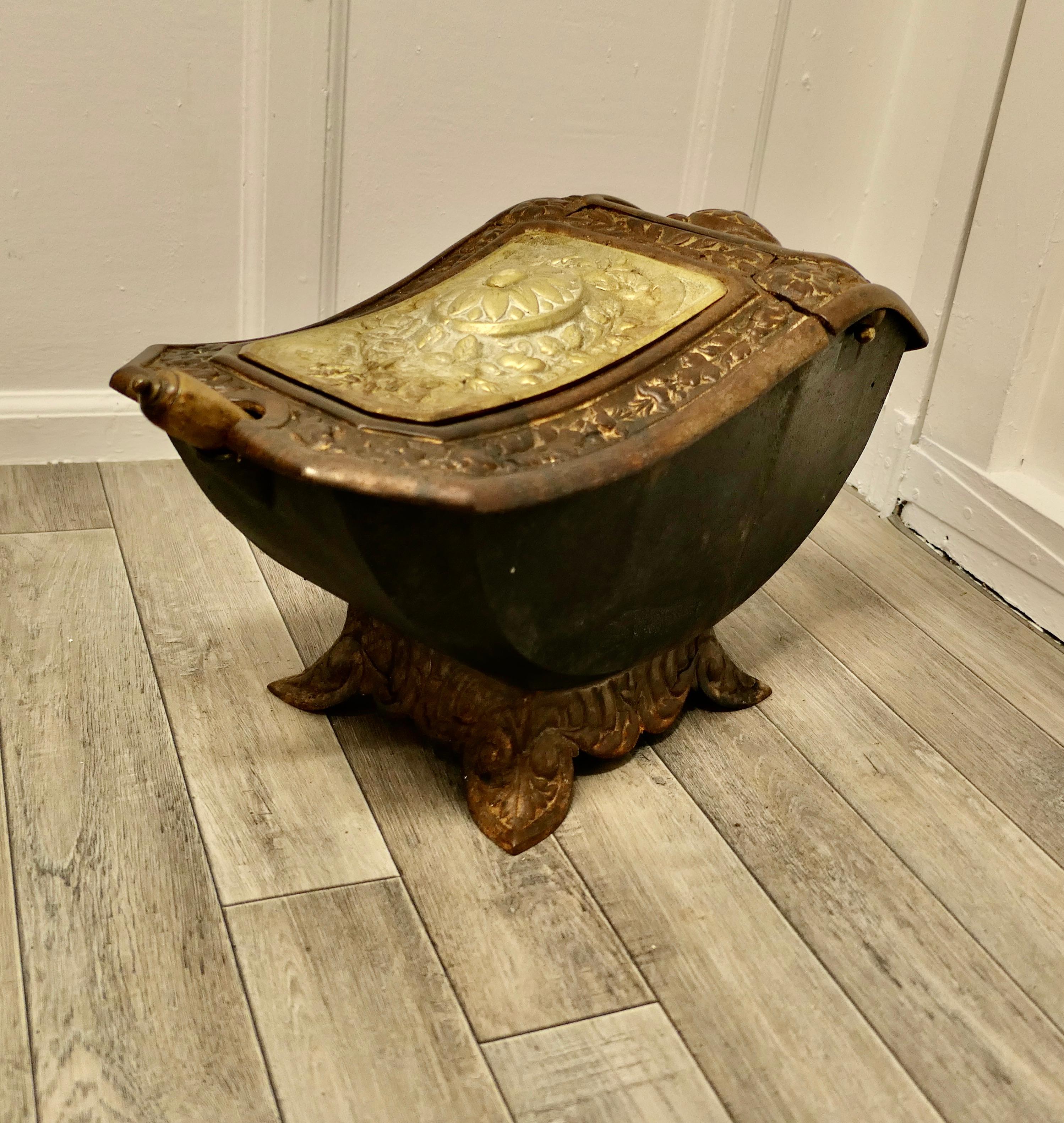 19th Century cast iron and brass Art Nouveau coal Scuttle

Cast iron and brass coal scuttle with a beautiful flower and leaf design.
The coal is accessed by lifting the brass lid to reach the boat shaped coal hod with the brass shovel.
This is a