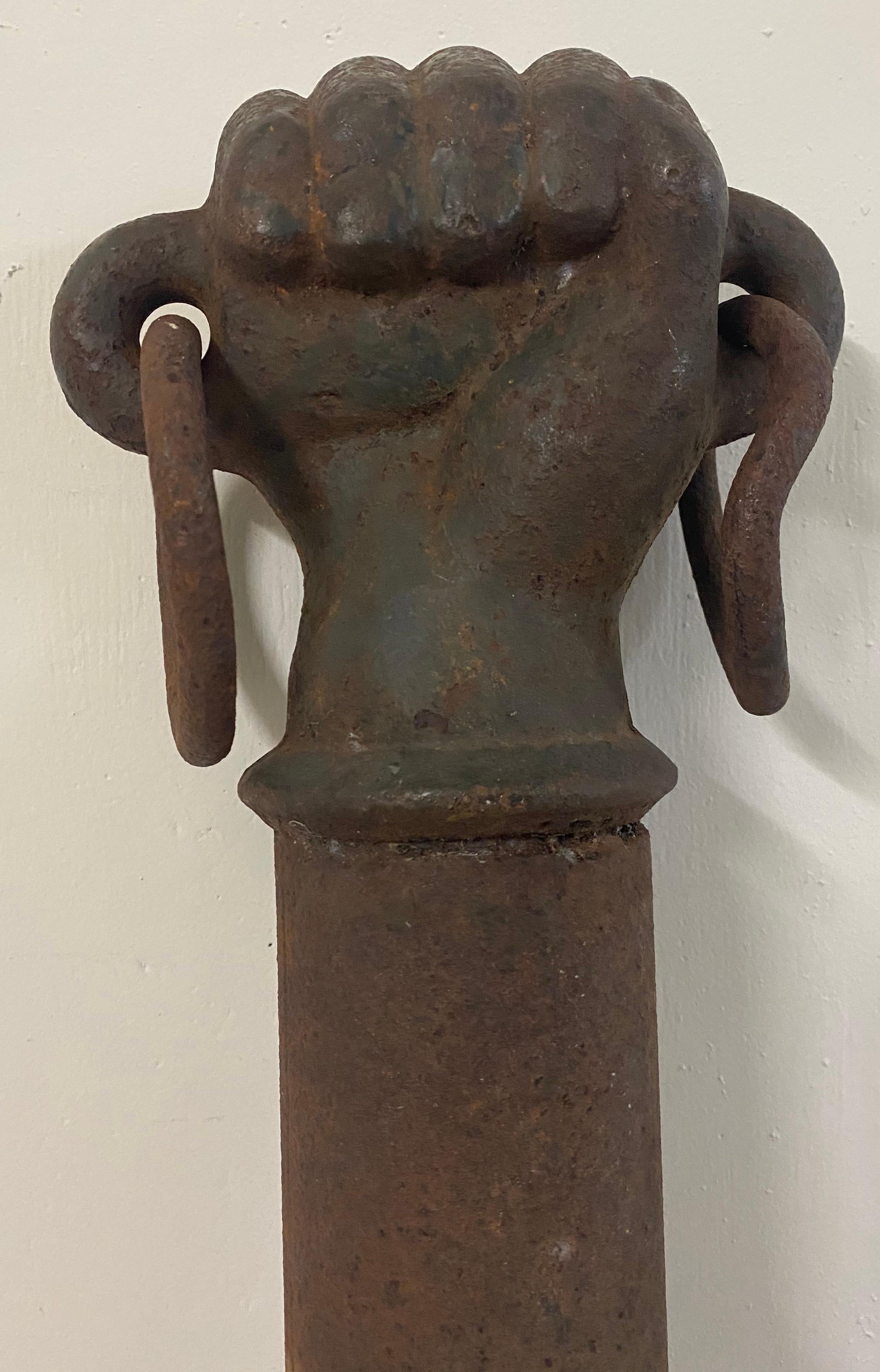 19th century cast iron clinched fist hitching post

Antique hitching post of a fist mounted on a tall iron post

Fist dimensions 7