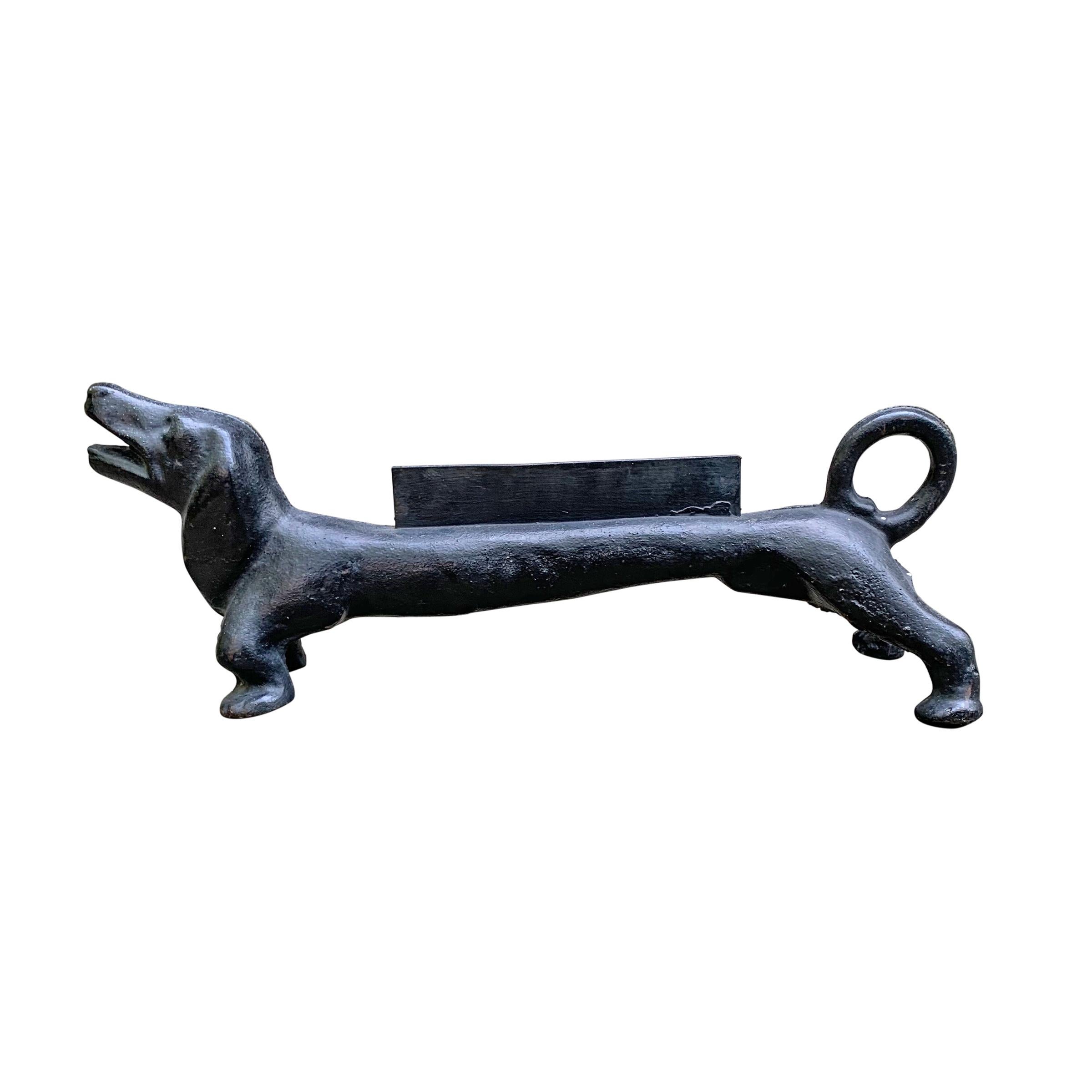 A whimsical late 19th century American red painted cast iron dachshund boot scraper, with an open mouth and sweet expression.