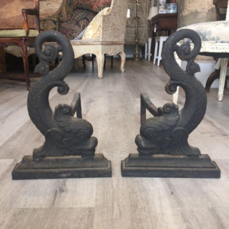 Pair of 19th century cast iron dolphin-form andirons, scrolled form on a plinth base. Most likely Bradley & Hubbard, Meriden, Connecticut, circa 1886-1900.