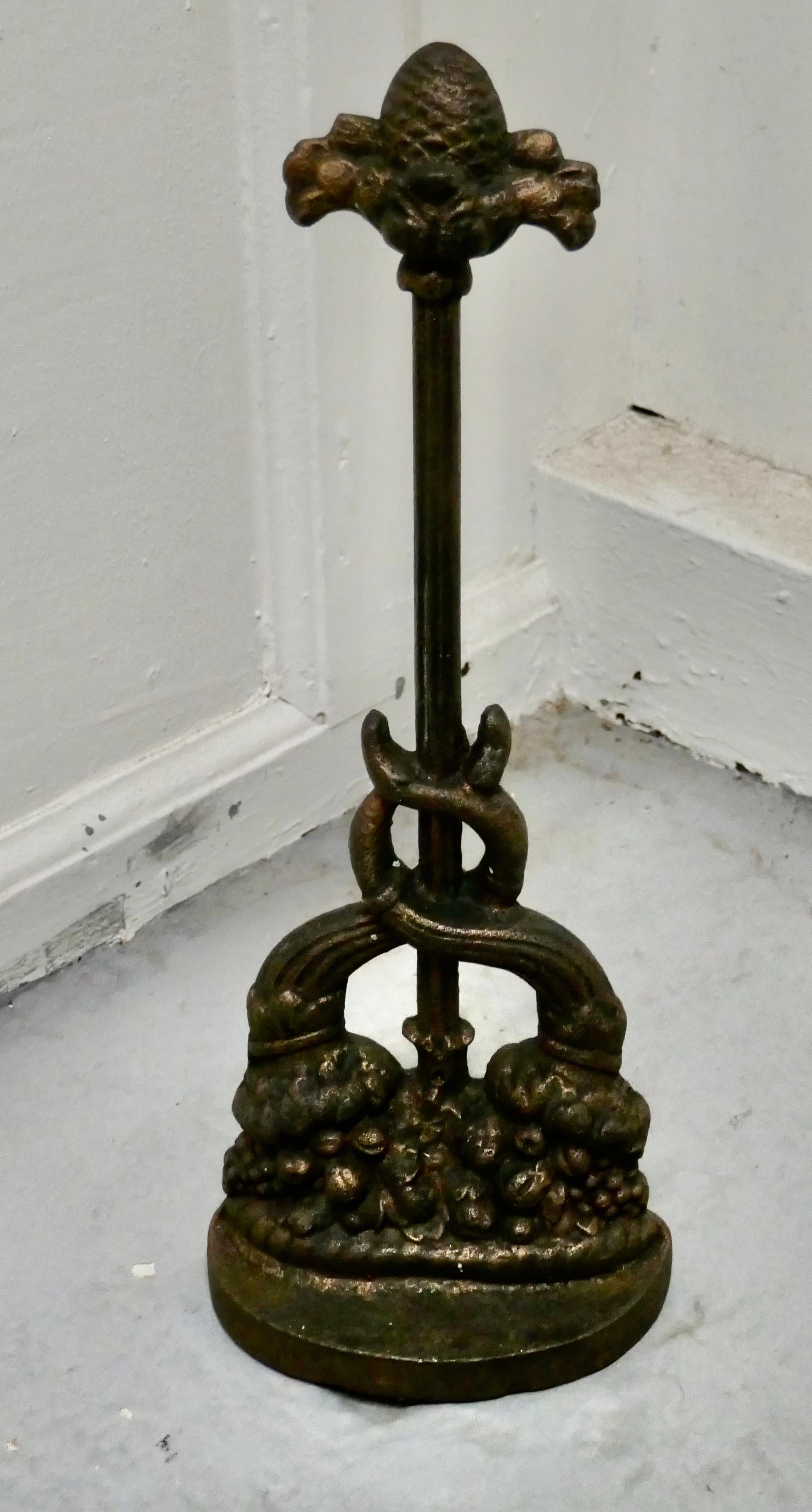 19th century cast iron door stop by the Baldwin Foundry

Needless to say a heavy piece which though worn with age still retains some of its original gilded finish
At the top there is an acorn, and the base is in the form of woodland fruits and