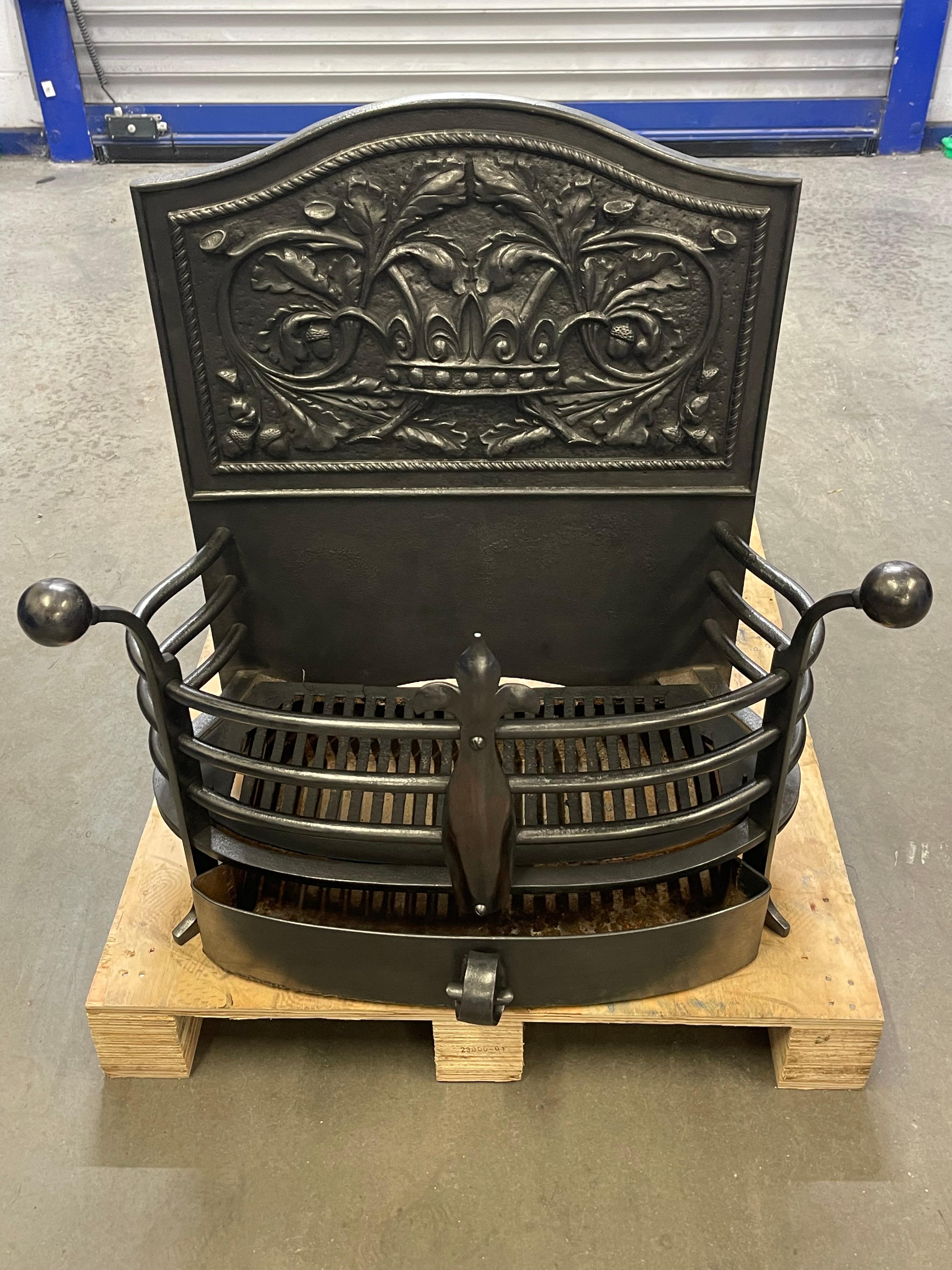 19th Century Cast Iron fire basket originally commissioned for a Manor House in Somerset. 

Featuring a royal crown to the back and scrolled foliage leaves with acorn detailing.
On top of scrolled hand iron legs. An elegant and untouched original