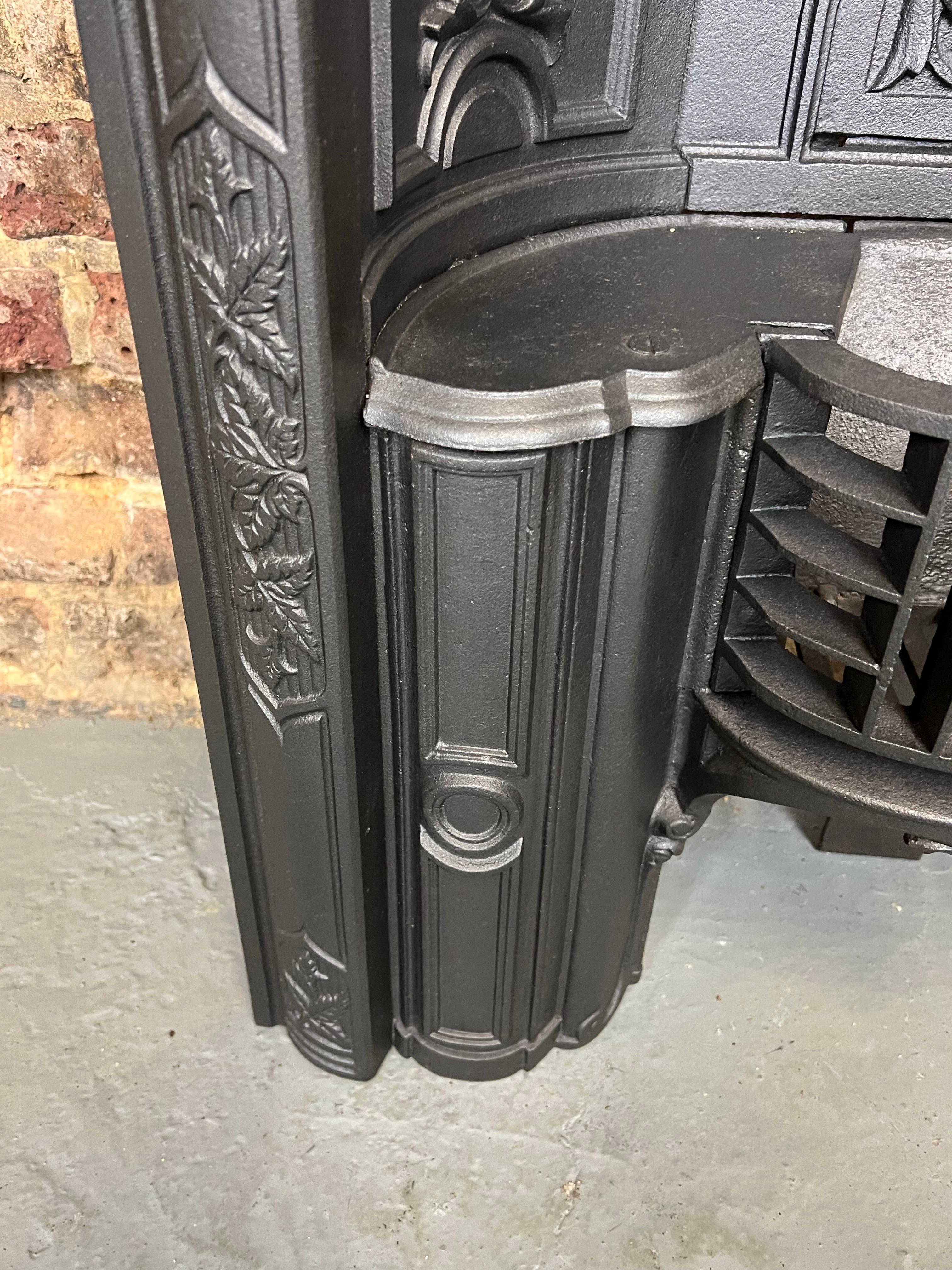 19th Century cast iron fireplace insert
also known as a Victorian arched hob grate.
English made with detailed curved recessed panels, classic floral decorative detailing to the arch, flap and side return panels.
In good condition. Blackened lead