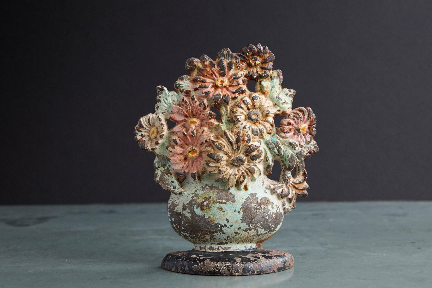 Lovely late 19th century cast iron hand painted polychrome flower bouquet in vase doorstop with it's original paint and fantastic patina. Heavy, solid piece of iron.