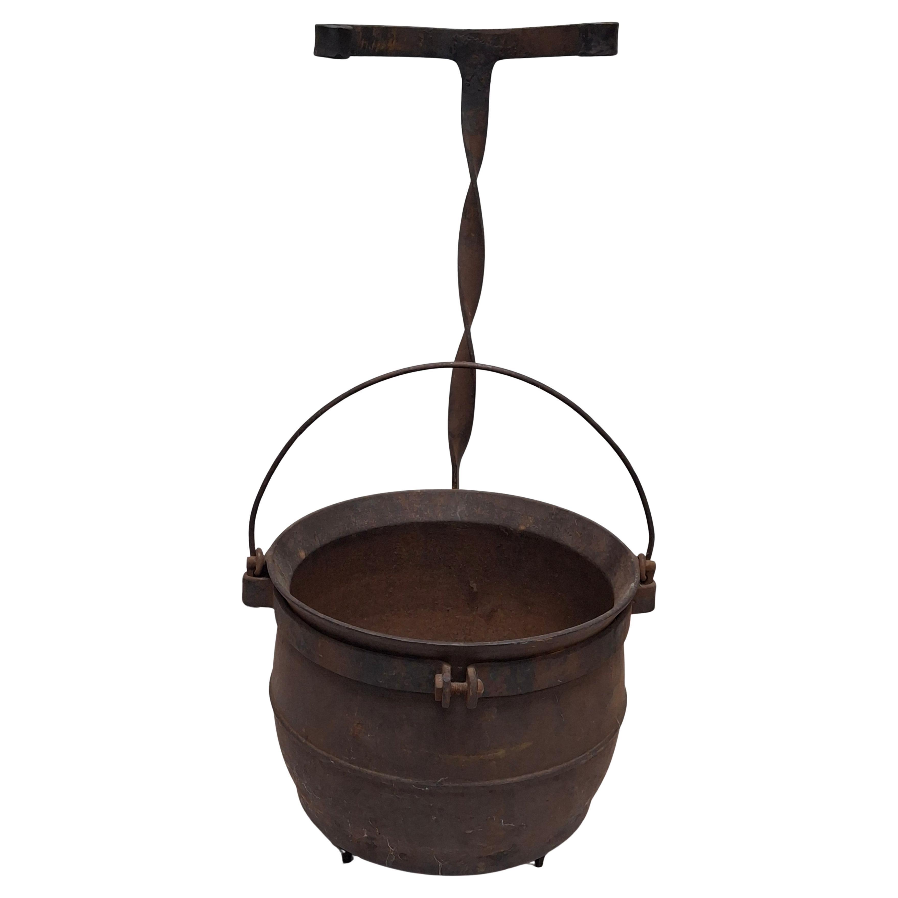 A 19th Century Cast Iron Handled Cauldron with Stand / jardiniere.
Measures: 11.5
