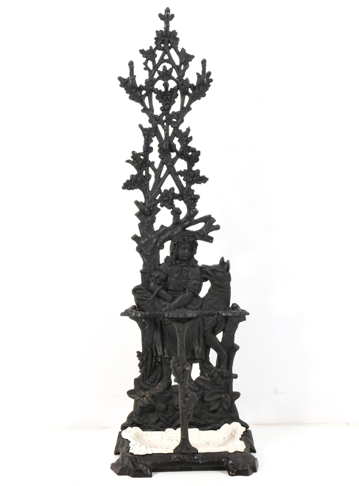 Magnificent and rare Victorian porte manteau or hall stand. 
Design by M. v. E. & Co. Breda.
Striking Dutch design from the late 19th Century.
Cast iron coat rack with umbrella stand with the original lacquered  removable cast iron drip tray!
Design