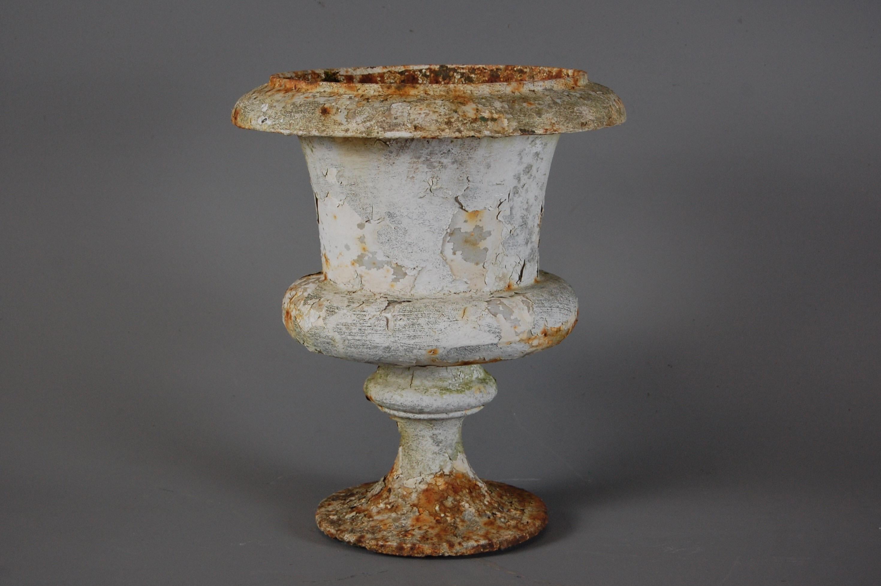 19th century cast iron urn, layers of crusty paint.
 