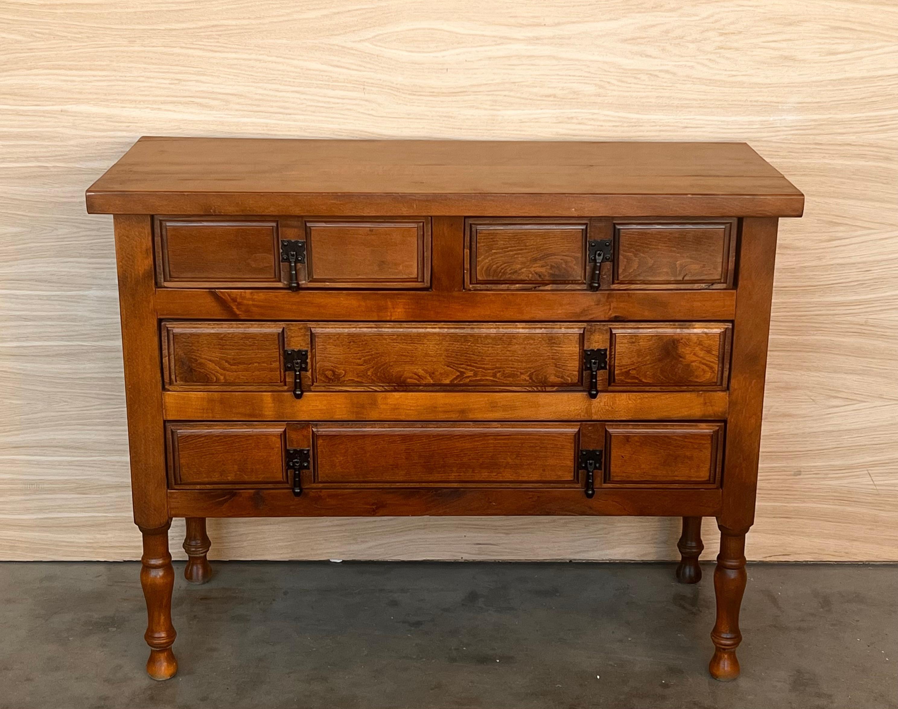 19th century Spanish antique walnut chest of four drawers and original iron hardware.
You can use like a commode or chest of drawers
This elegant console was crafted in Spain, circa 1890. The sofa table with four legs features a four carved drawers
