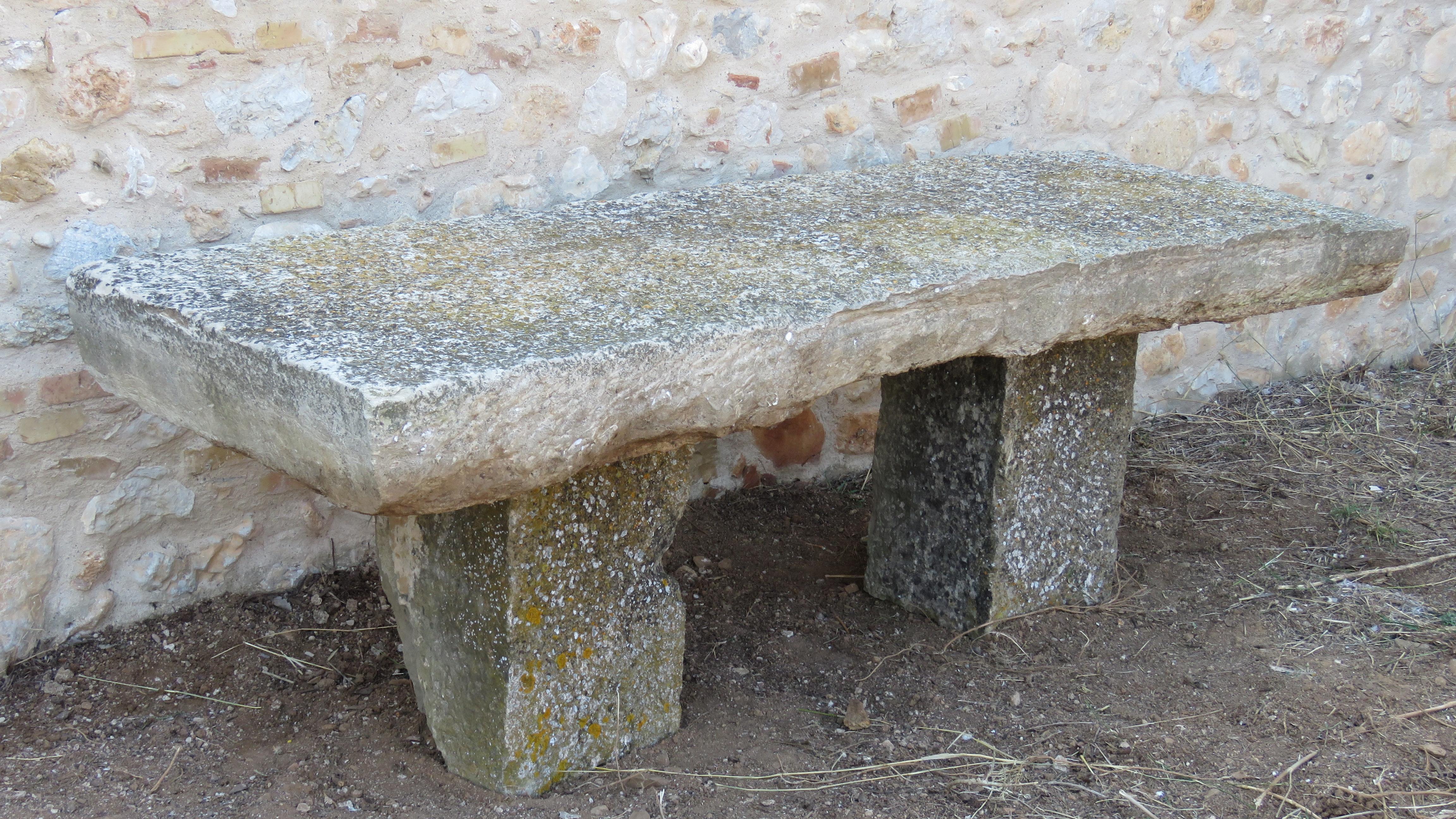 Of massive rectangular roughly hewn form, with tapering apron, raised on rectangular section plinths. 

Plinths height: 25 