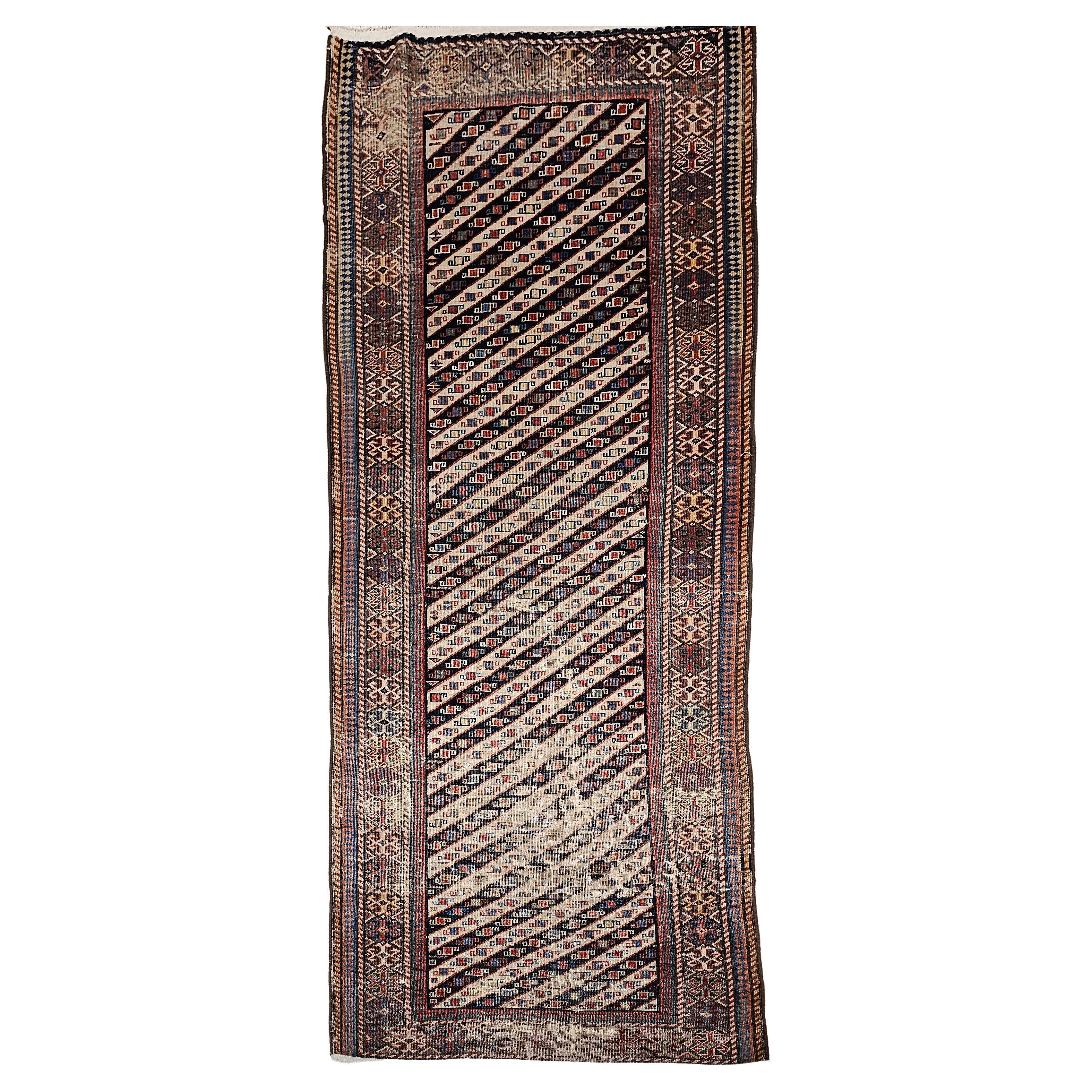 Beautiful and colorful vintage Caucasian Gendje Kazak runner from the late 1800s.  This Kazak is unusually large with the “Sevan” pattern set in a dark red color field.  The Gendje runner is in an allover skewed stripe pattern with an alternating