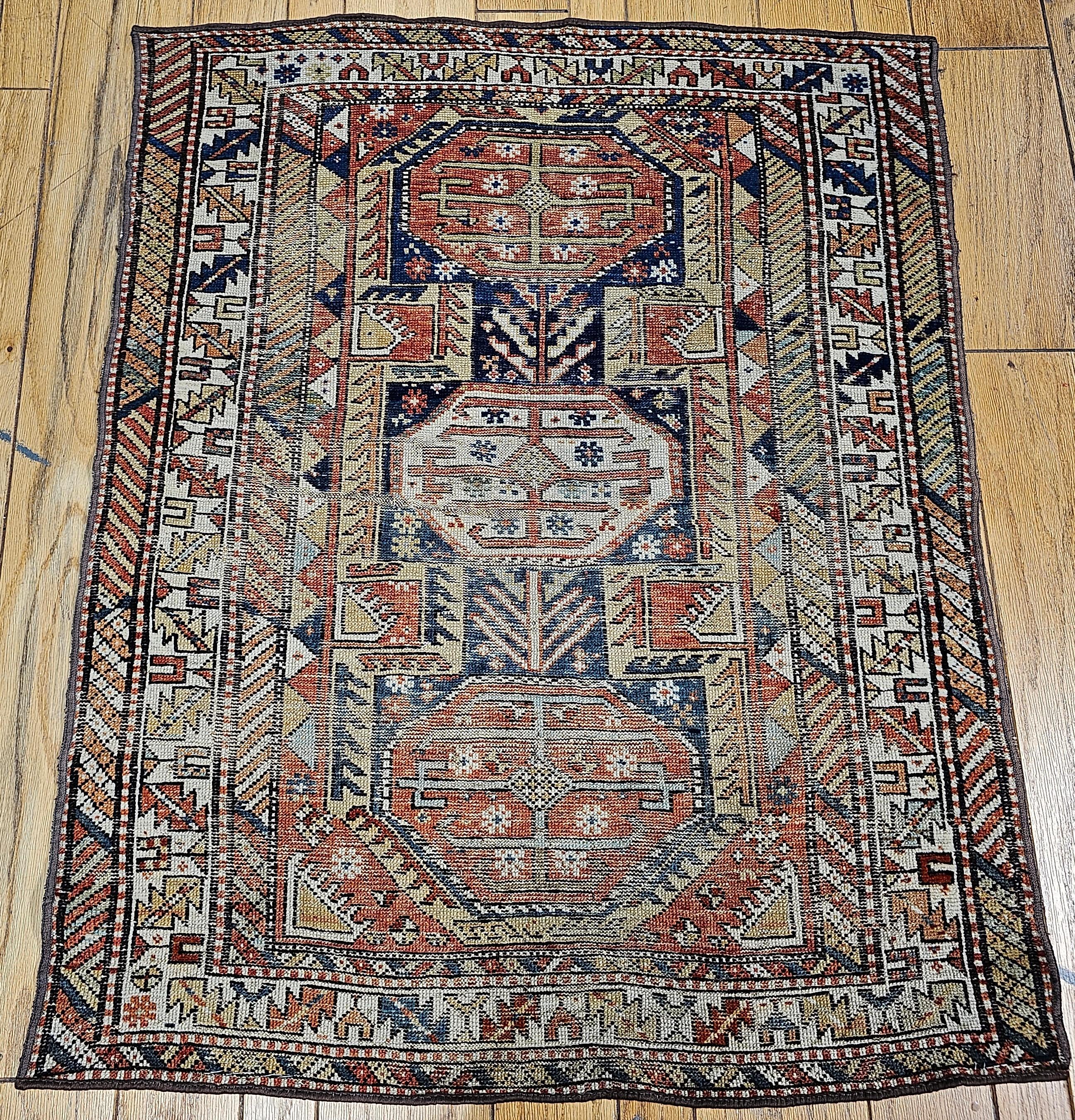 A beautiful Caucasian Shirvan area rug from the southern Azerbaijan region of the Caucasus is in geometric medallion design with an abrash navy blue field.   The Caucasian rug has a triple medallion design in red and ivory set in an abrash