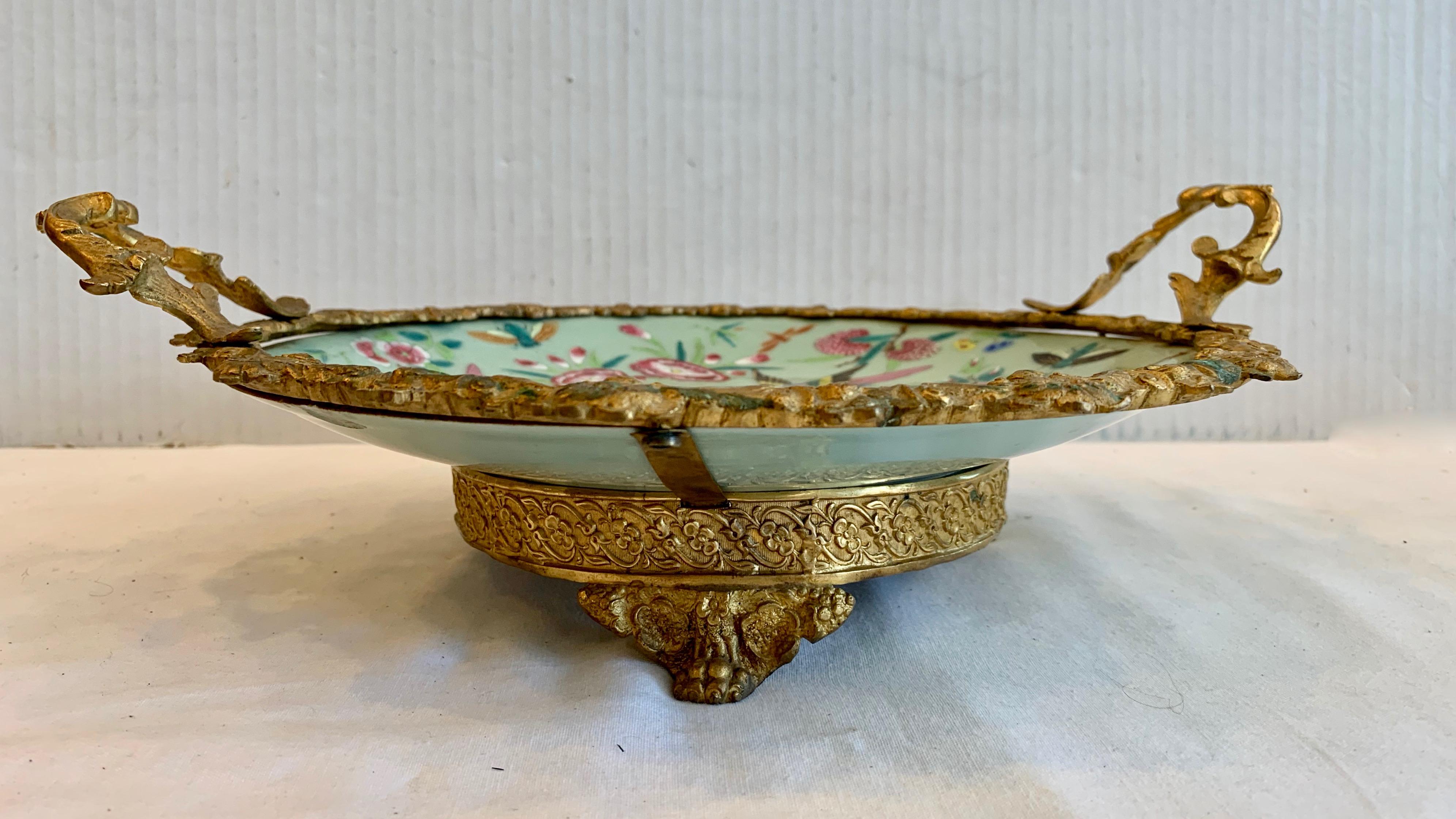 Superb quality and details. Beautiful celadon green color - profusely 
painted with birds and butterflies. Mounted with elaborate dore' bronze
framework and handles