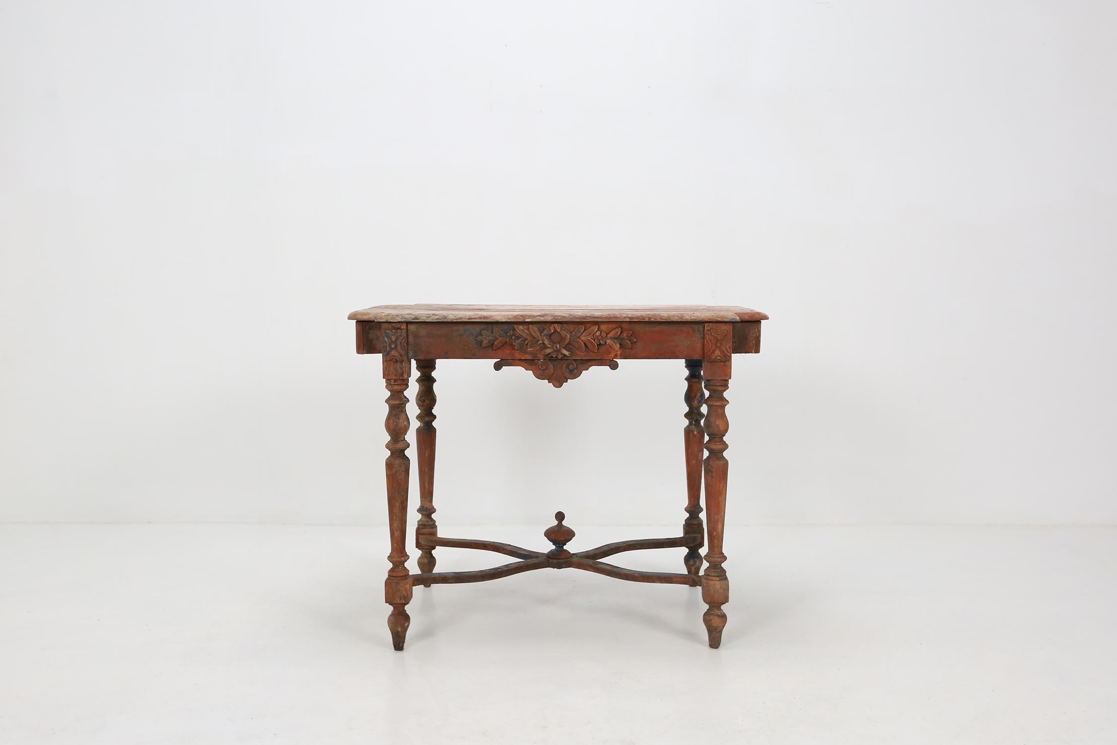 Antique rustic center table with some beautiful sculptural details and great patina on the wood.