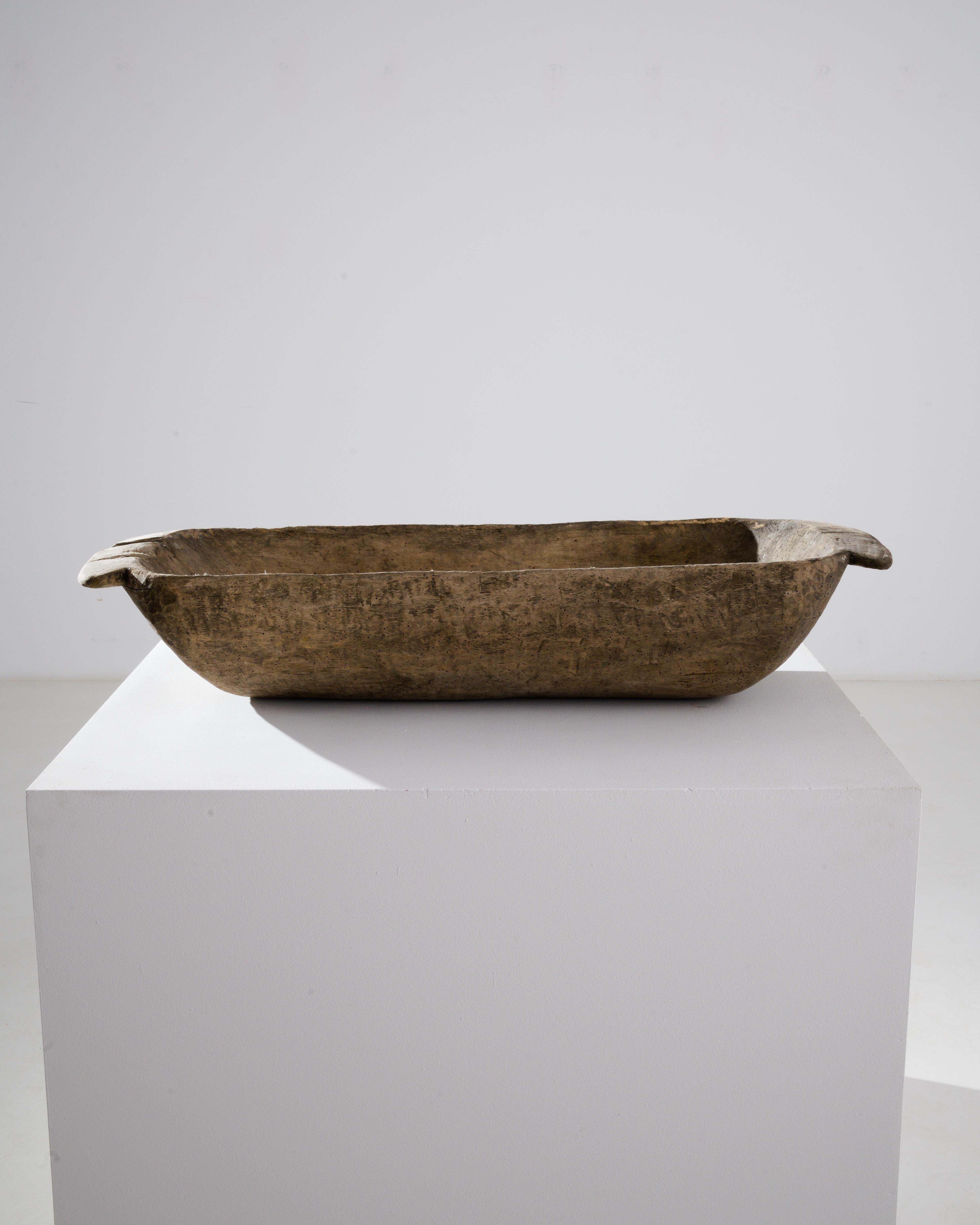 The simple form and tactile surface of this wooden bowl give it a timeless appeal. Made in Central Europe in the 1800s, the rough-hewn texture indicates that this piece was carved by hand from a single piece of wood, formerly used to store rising