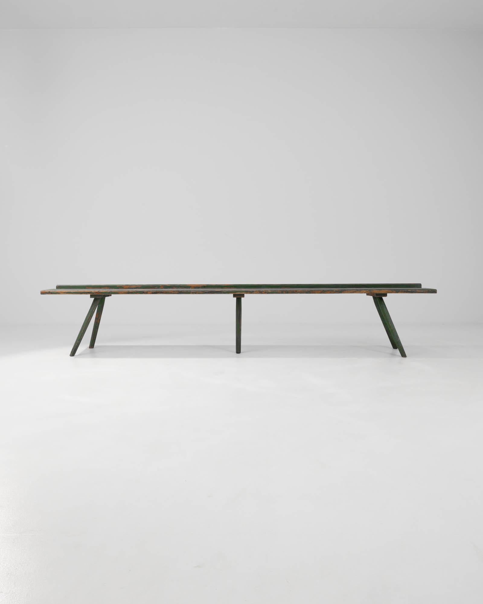 Introducing our enchanting 19th Century Central European Wood Patinated Bench, a captivating relic of bygone eras. This charming piece boasts a unique green patina, weathered gracefully over time, showcasing its rich history and character. Crafted