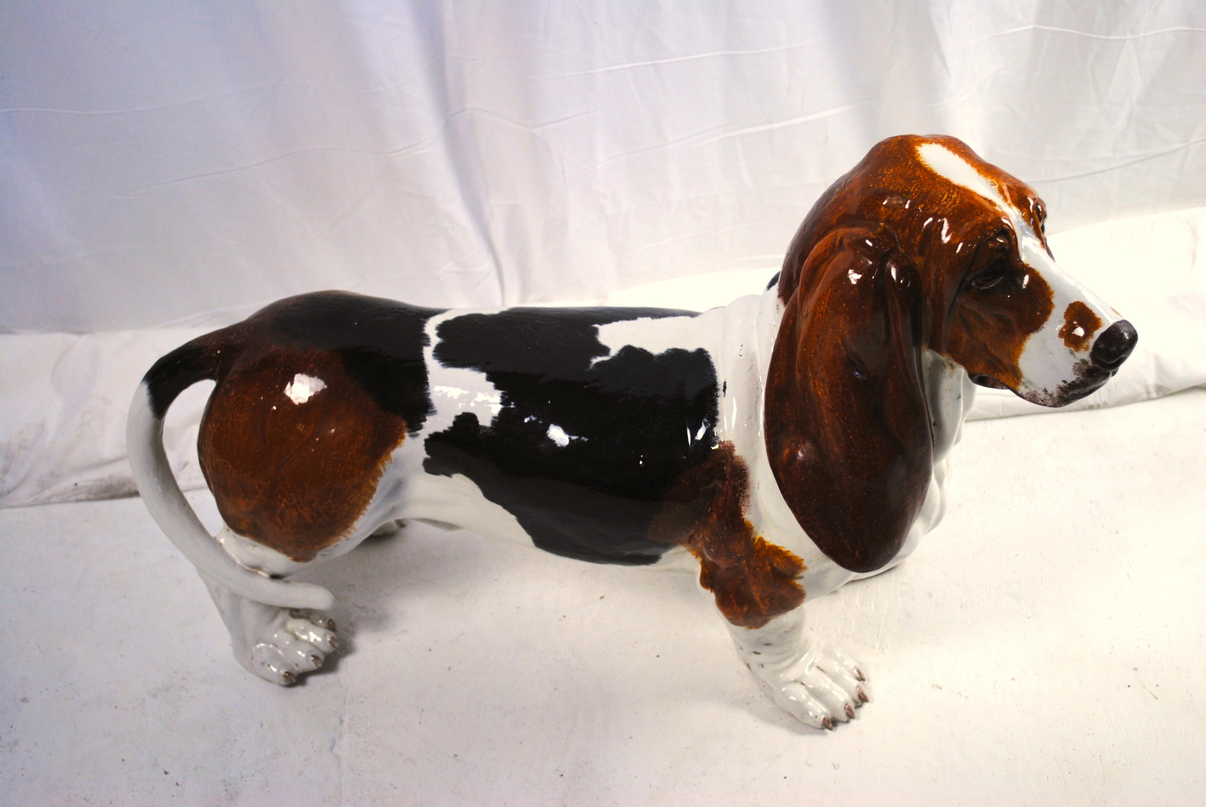 A ceramic figure of a life-size basset hound, dated 1907s. A rear and adorable depiction of a basset hound. Unmarked but very probably made by Montebello in Italy. 
Very good glaze and casting. The stance and expression is very lifelike and the