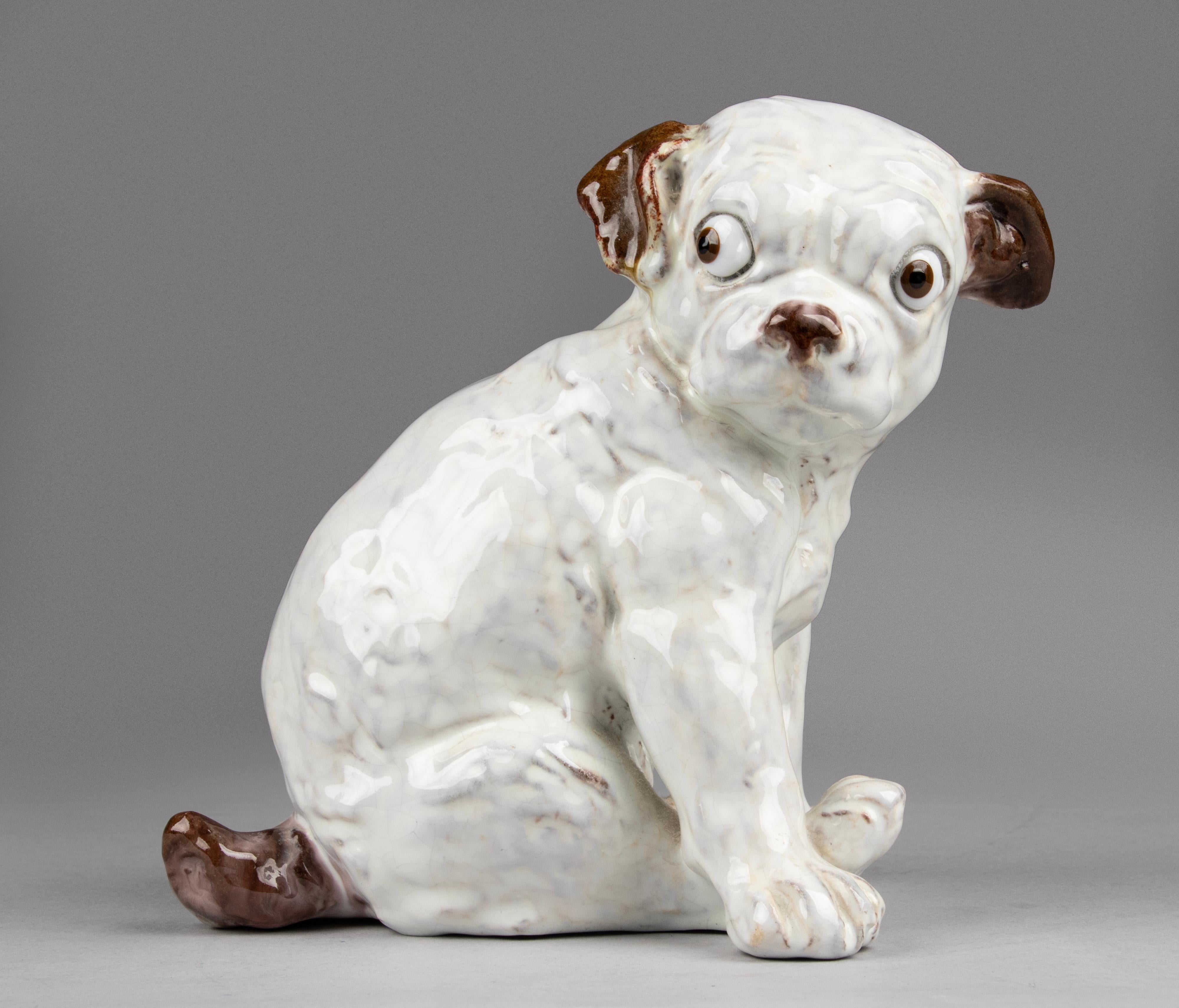 Beautiful ceramic sculpture of a puppy dog. The sculpture is made of clay / terra cotta and has a beautiful thick layer of glaze. The appearance has striking resemblances to a real puppy. The anatomy, but also the face expression. The eyes are made