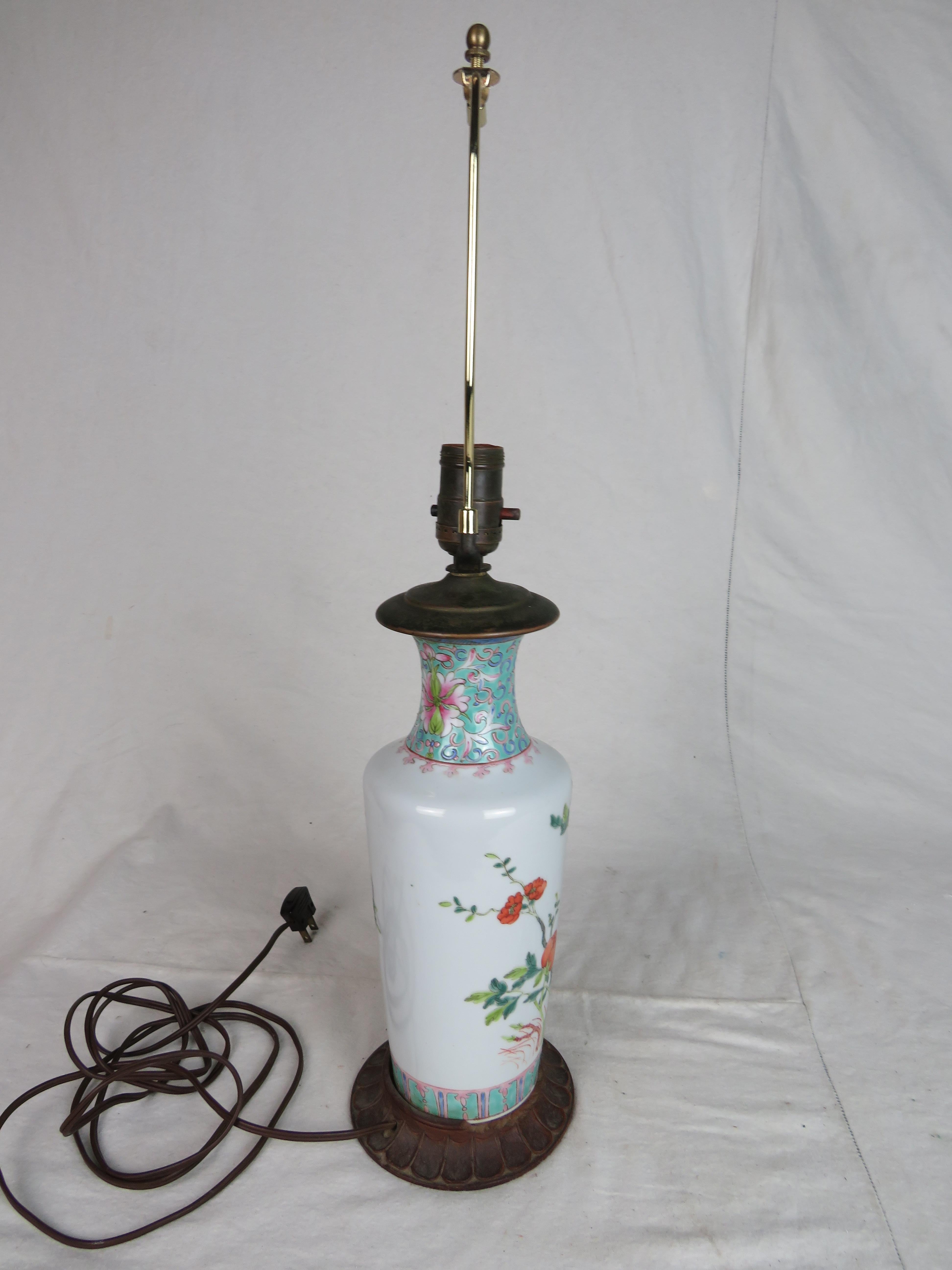 Beautiful 19th century white ceramic vasiform table lamp with detailed flowers and bird motif. Supported by a walnut wood base and copper neck. This piece fits cozily in any home.
   