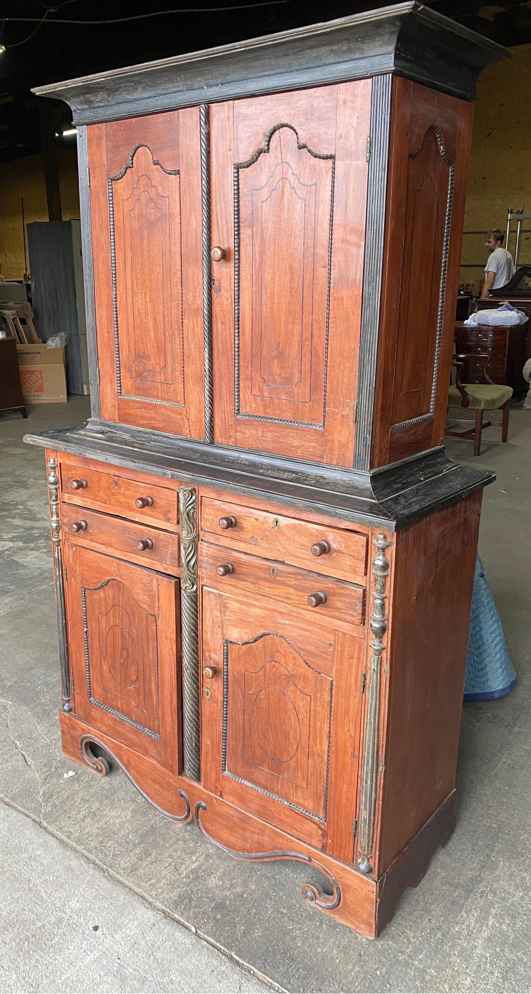 19th century Ceylonese / East Indies jackwood and ebony 4 door press or cabinet with 4 central drawers between the top and bottom. Hand carved and applied ebony pilasters to case and moldings to overly exaggerated feet. Beautiful form from the Dutch