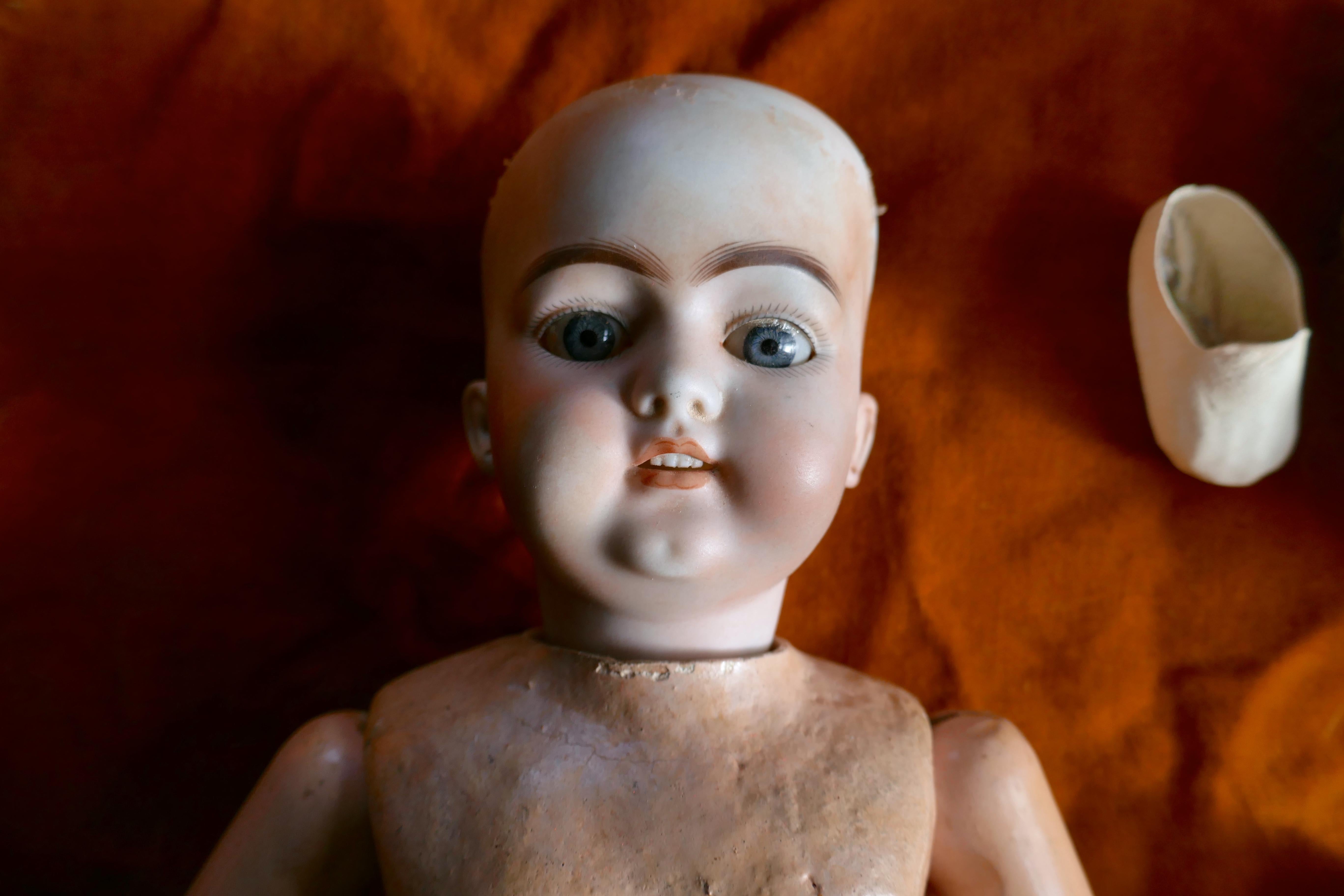 19th century character doll possibly by Kestner with wig and clothes.


The porcelain head has JH 1019 DLP, 7, Germany, on the back, she has glass eyes in pale blue/grey, teeth with a dimple on her chin and pierced ears.
The body is made in