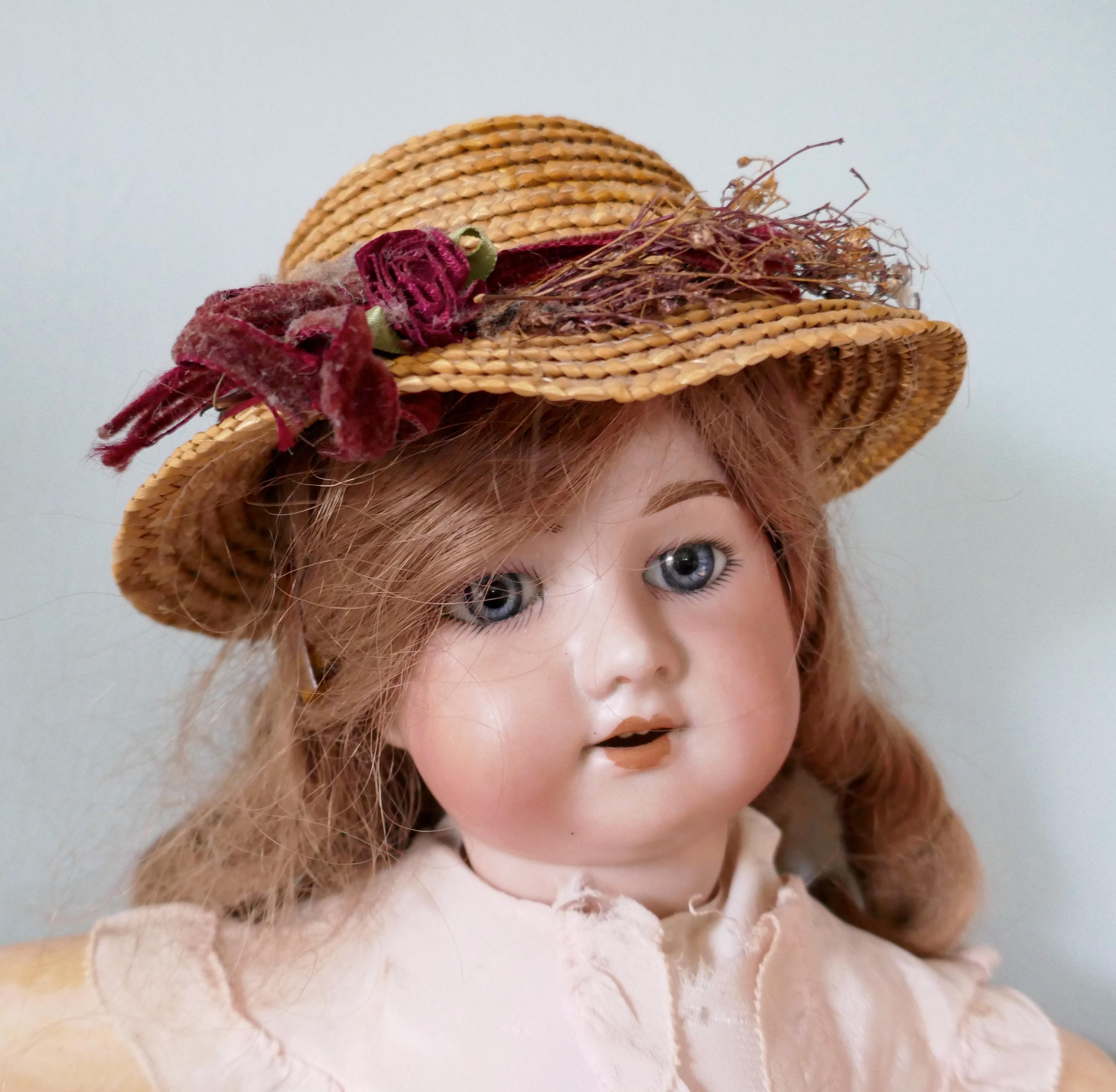 19th century character doll with wig and clothes.


The porcelain head has 5 on the back and has a slope to the open end she has sparkling glass eyes in grey and teeth 
The body is made in composition it has articulated arms and legs, with