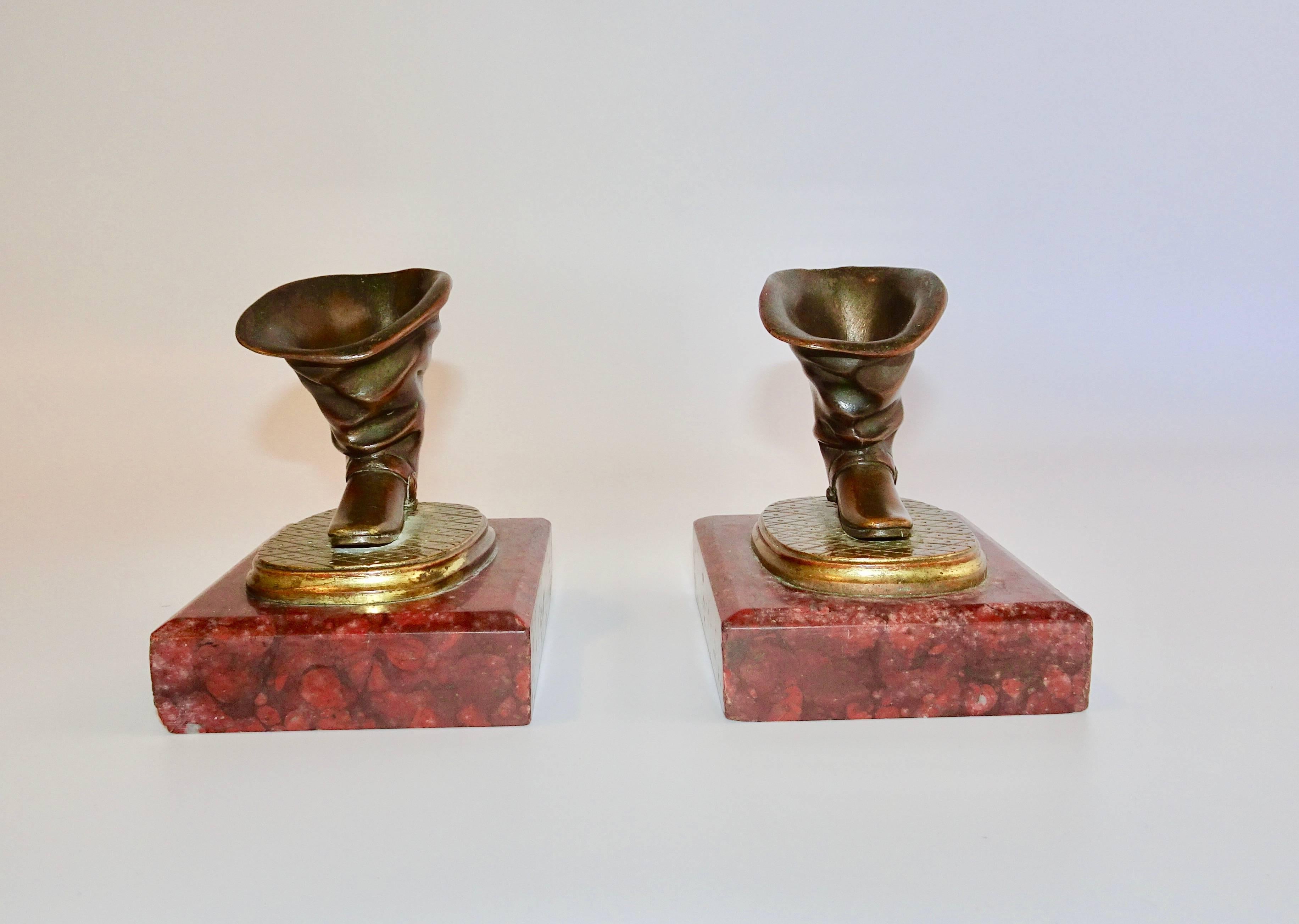 This very unusual pair of 19th century Charles X gilt and metal quill holders are in the shape of boots with spurs. They are mounted on beautiful dark red marble plinths. They make quite the conservation piece on a desk.