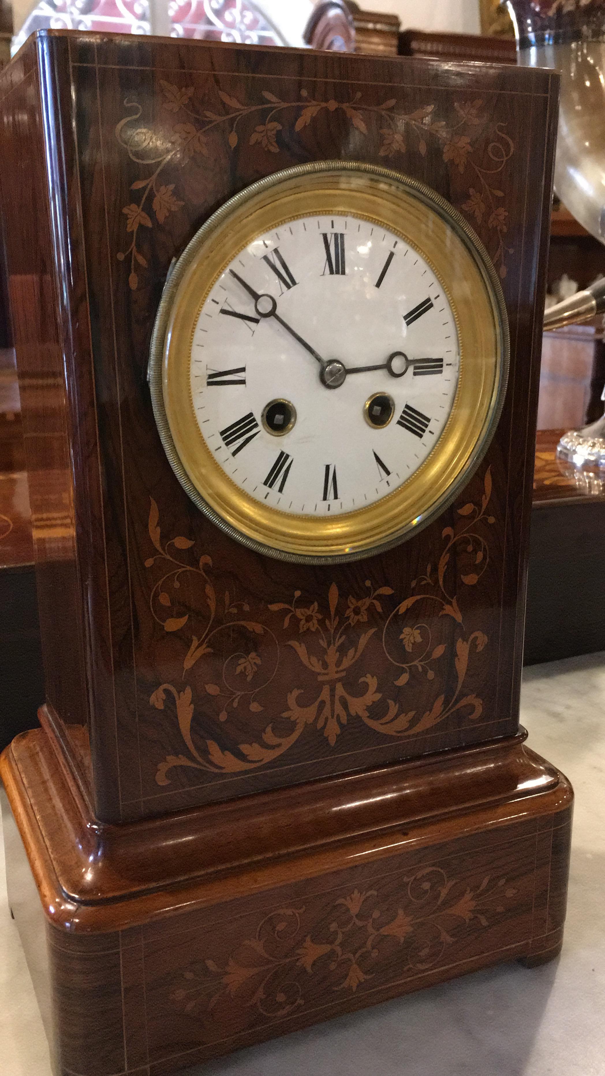 Rosewood Charles X clock with two incense burners also in rosewood and inlaid in boxwood. Restored and functioning. Mechanism signed Japy Freres.
Japy Freres was founded 1n 1806 by Frédéric with his sons Pierre (finances/commerce), Fritz and Louis (