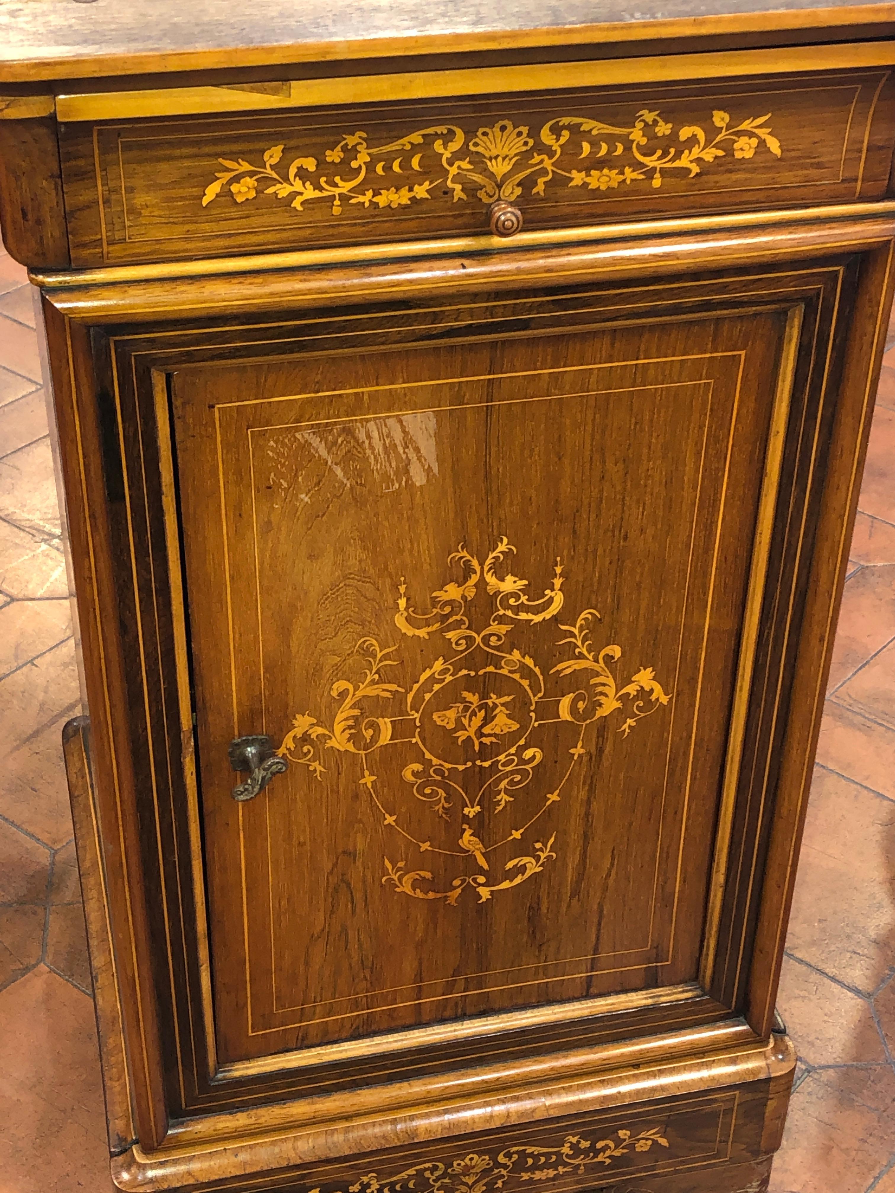 Fantastic French centerpiece, period Charles X, circa 1830, in rosewood and inlaid with boxwood.
Exceptional work with geometric and floral shapes. One door and two drawers, one of which is hidden in the lower part of the plinth. Original marble top