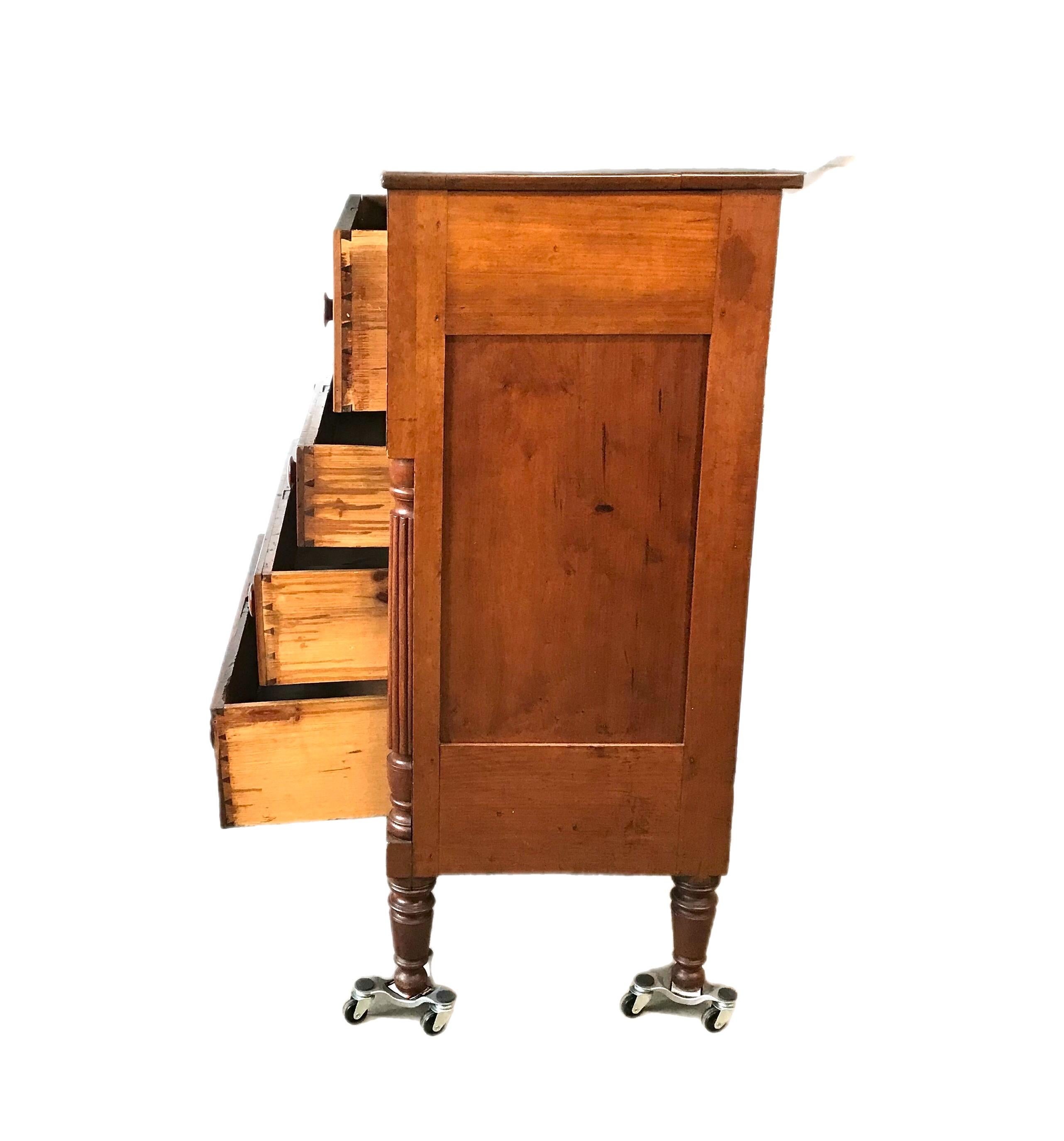 This is a beautiful chest of drawers with a warm cherry finish. The turned colonnade carving flaning the lower 3 drawers adds an element of elegance to the simple lines of this piece.