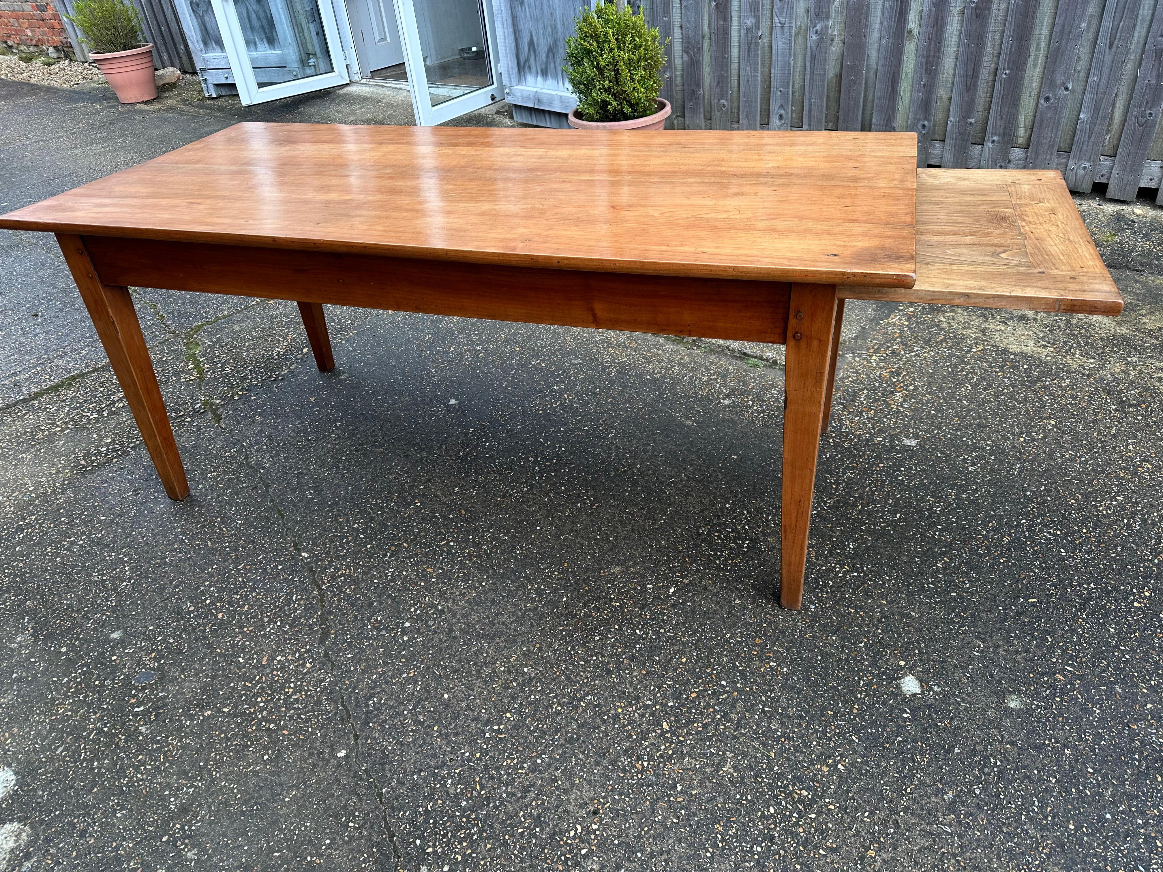 19th Century Cherry Dining Table with breadside and end drawer. Sits on four tapered cherry legs. Beadslide length 28