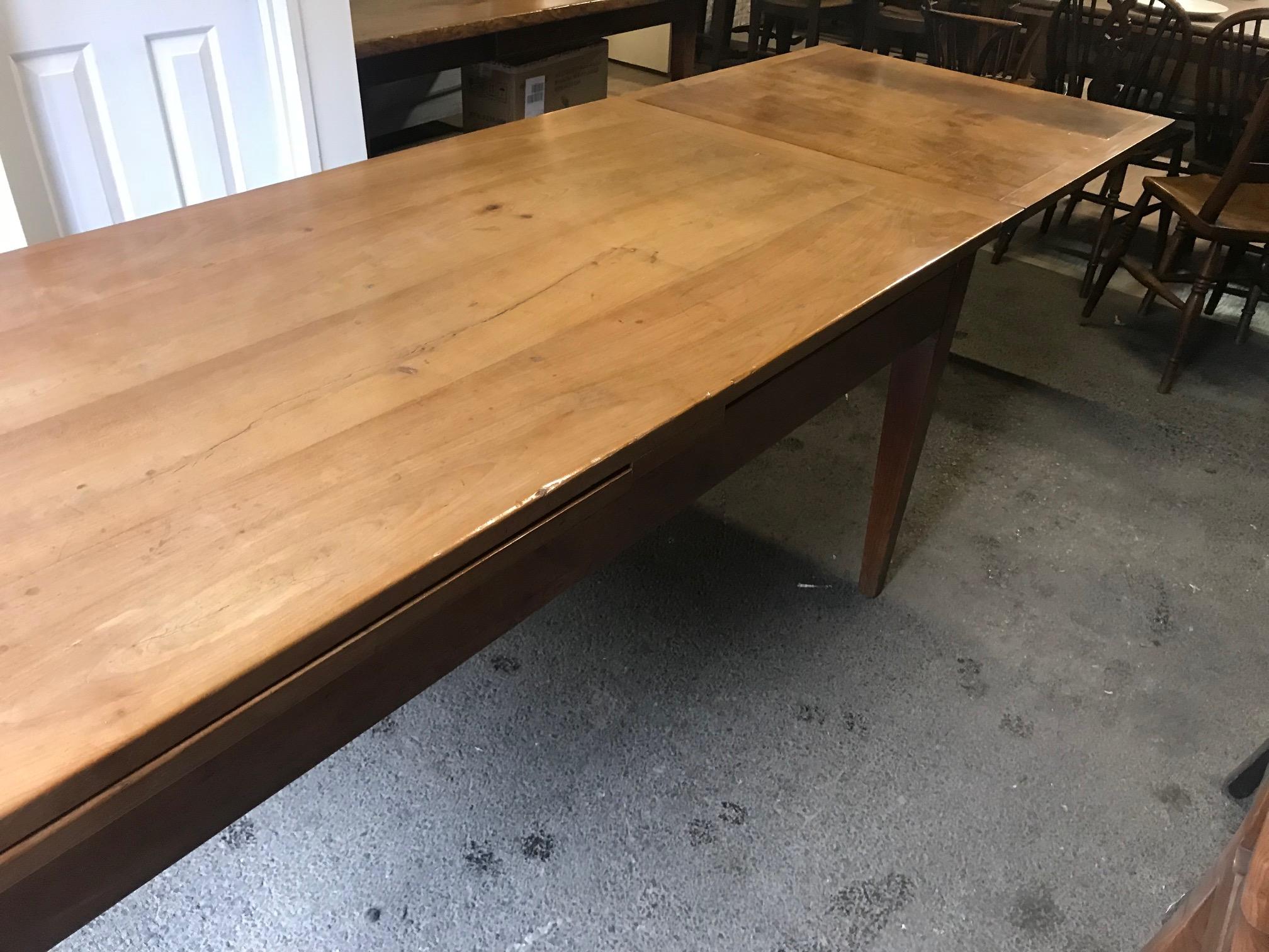 19th century cherry draw-leaf table. Beautiful 19th century cherry double extending table. Seats 8 people comfortably when closed and 12/'14 when open. The table opens to 138