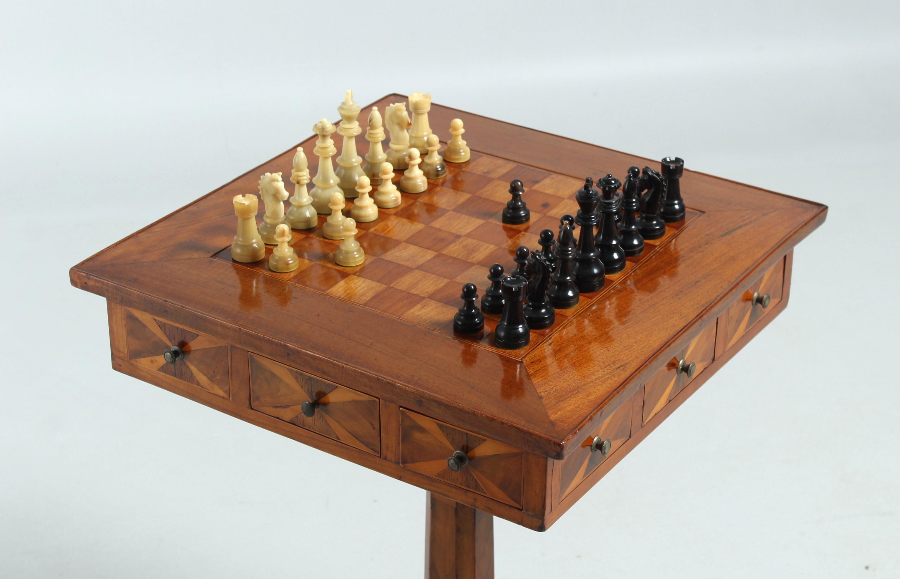 Antique chess table

Southern Germany
Walnut, cherry tree
19th century

Dimensions: H x W x D: 70 x 49 x 49 cm

Description:
Piece of furniture standing on a three-piece base with a centrally mounted table leg.

The square table top