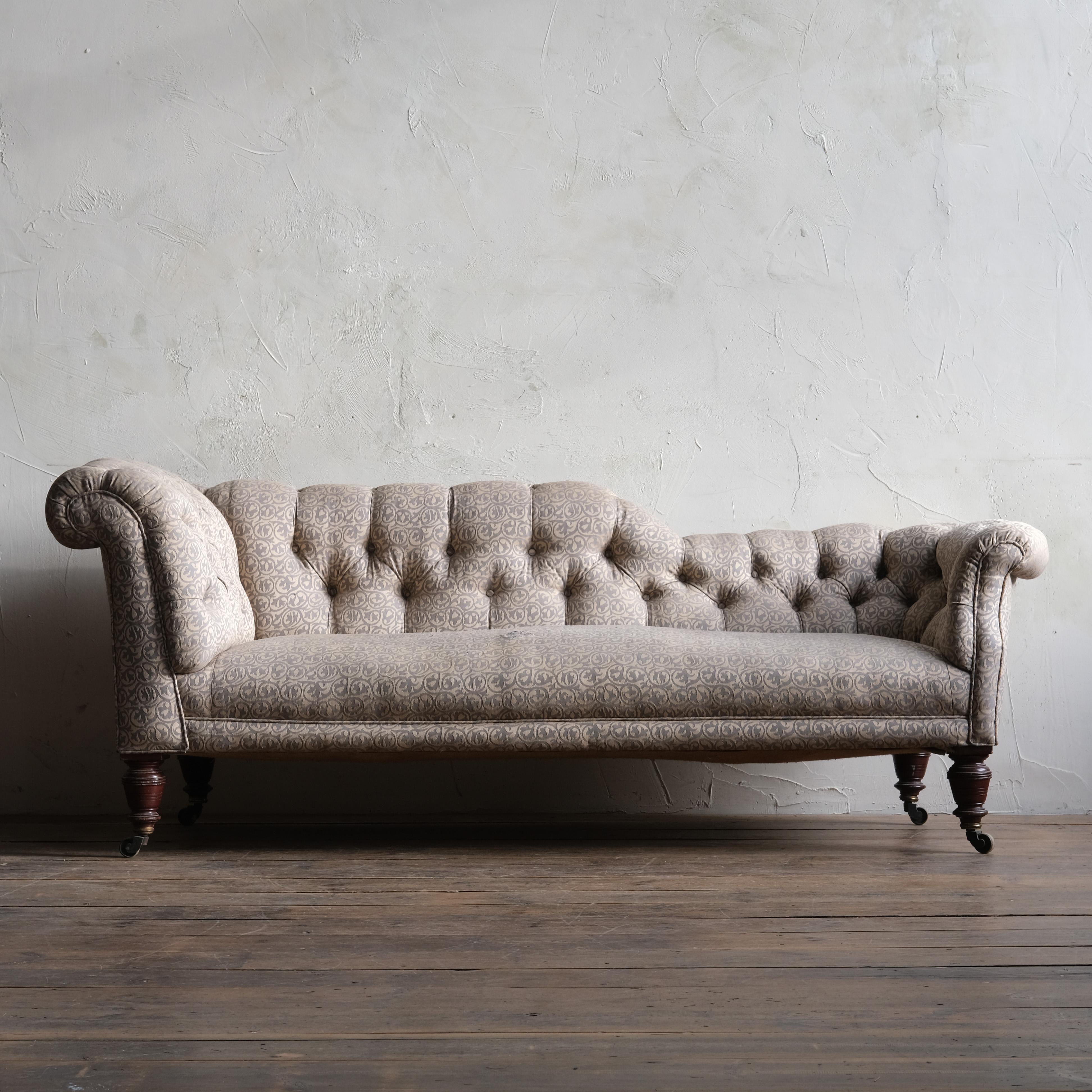 A 19th Century Chesterfield sofa / chaise lounge by Hampton & Sons of Pall Mall - London. Raised on 4 turned mahogany legs legs with the original stamped brass casters.

For upholstery.