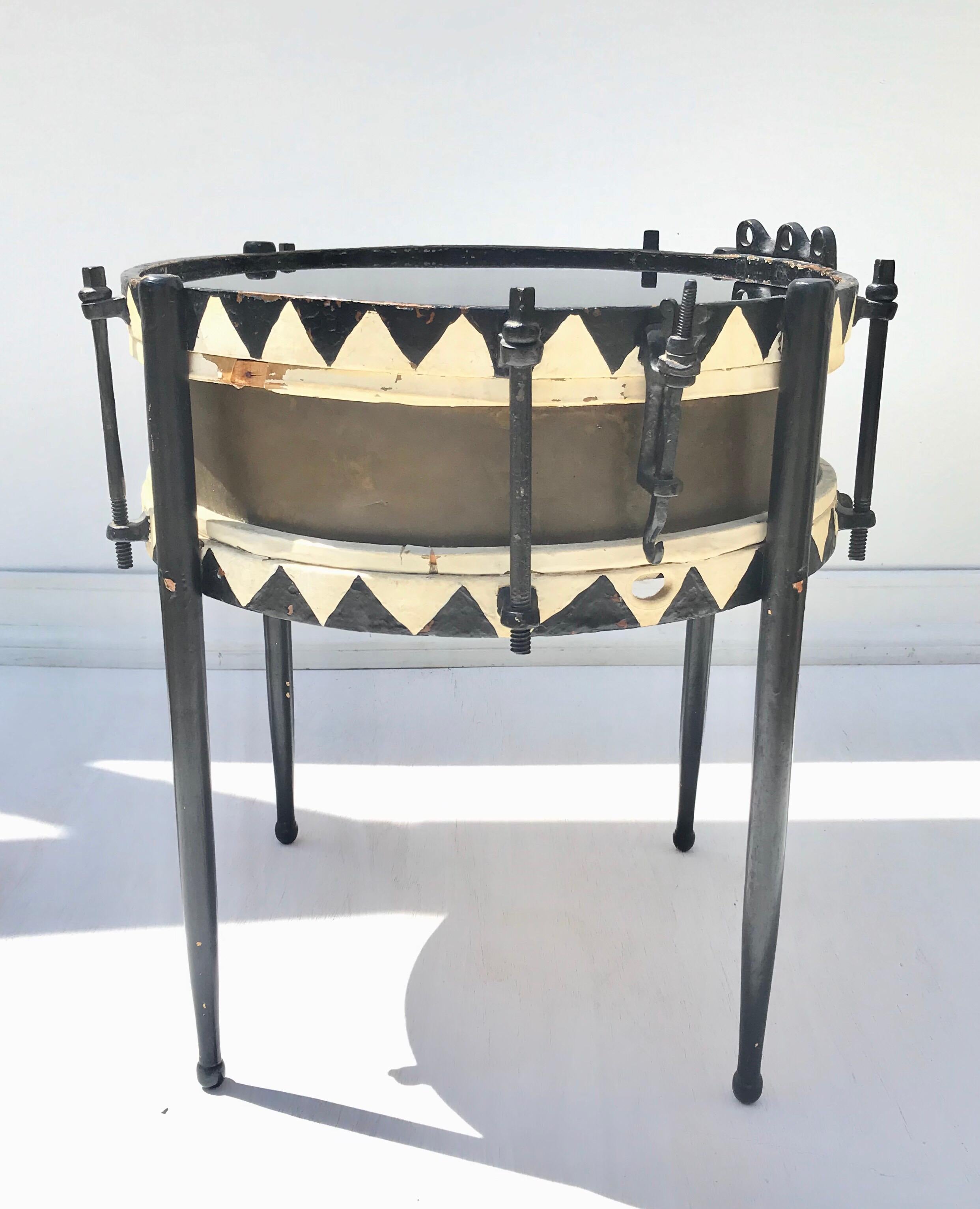 An usual and petite 19th century marching snare drum converted to a chic and timeless side table. The Austrian or German , late 19th century shell of cast brass is adorned with hand painted and now distressed black and white hoops and ebonized brass