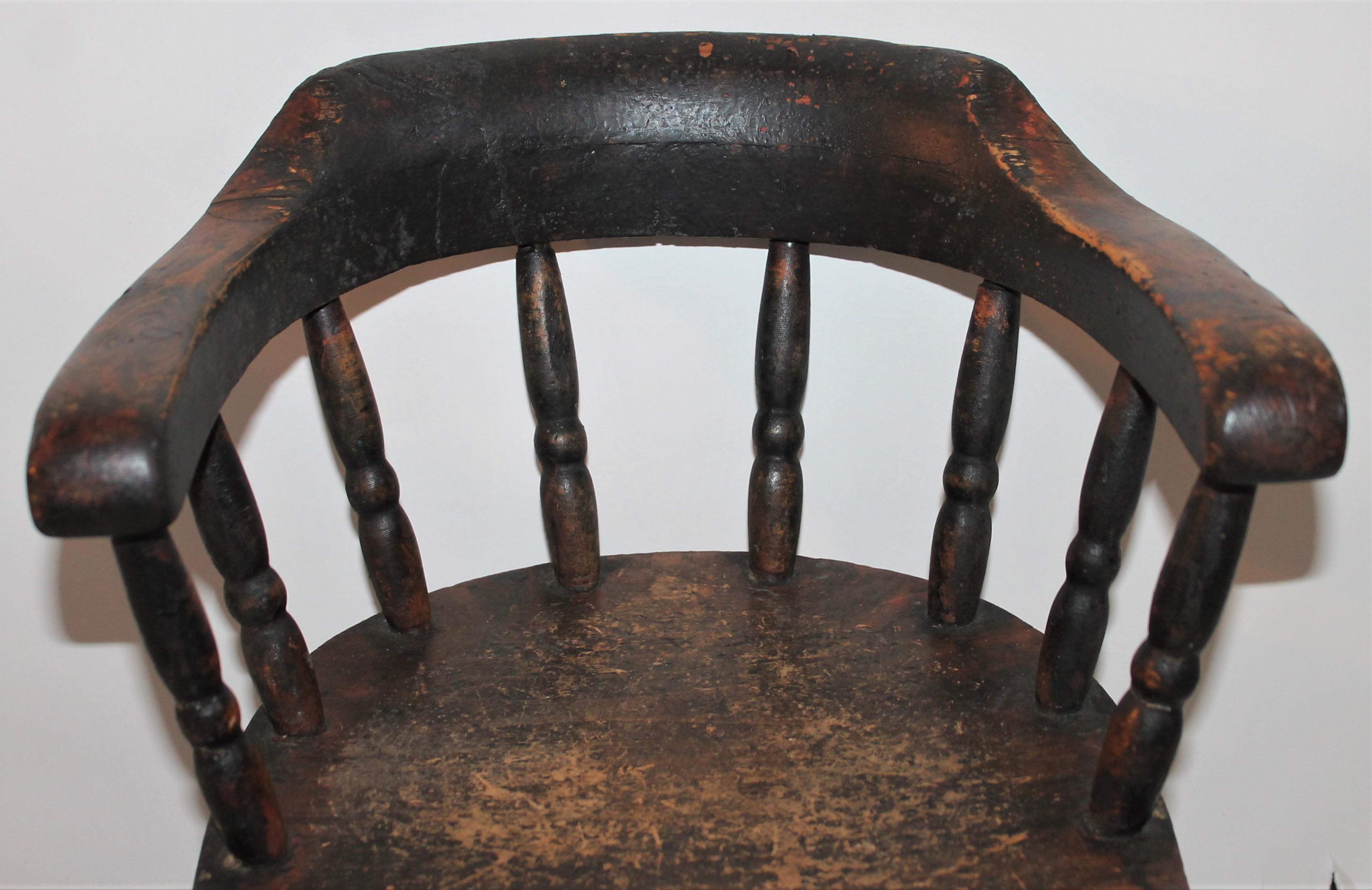 This fine mid western Child's captain’s chair in original painted surface is in great condition. Fantastic for a teddy bear collection or little child. This chair has wonderful aged wear and nice patina.