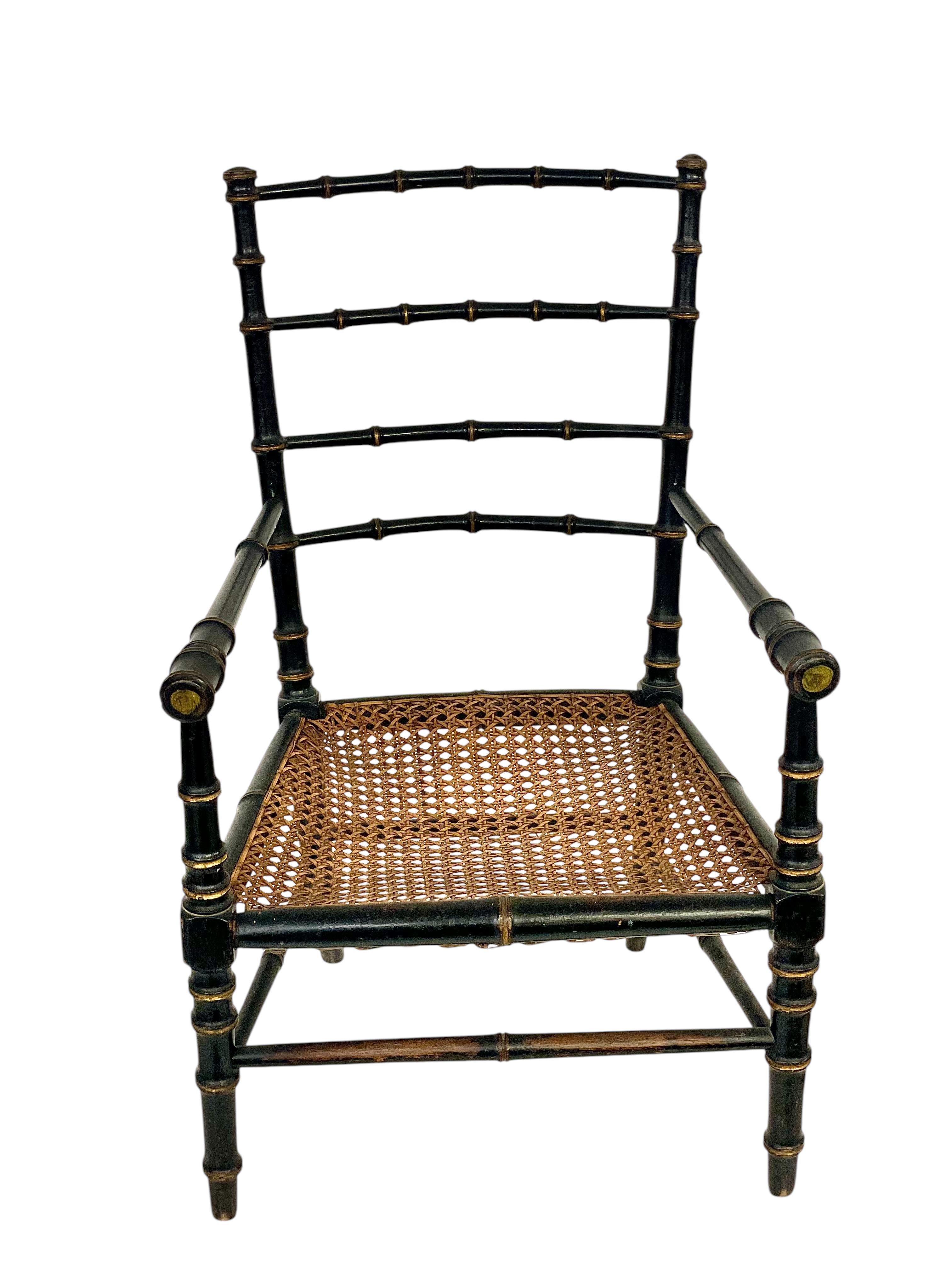This charming Napoleon III-era children’s chair is a delightful blend of craftsmanship and elegance, dating to the mid-to-late 19th century. Its design reflects the refined taste of the period, combining black lacquered faux bamboo construction with