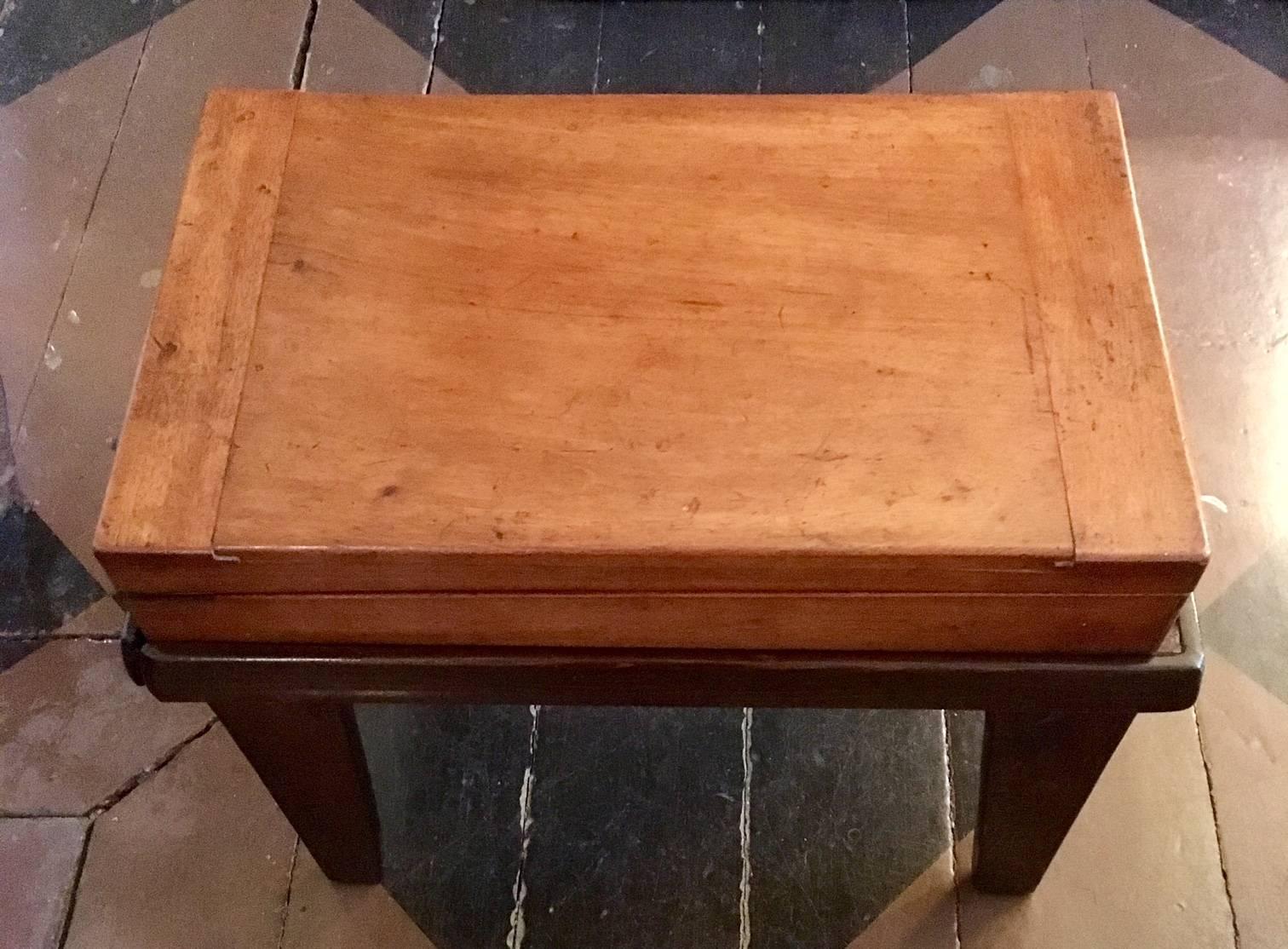 19th century child’s mahogany Bagatelle table, circa 1840, mounted on a period custom base. The shallow rectangular mahogany case is hinged to open as a felt lined playing table, with appropriate depressions and shaped corners, set upon a fitted