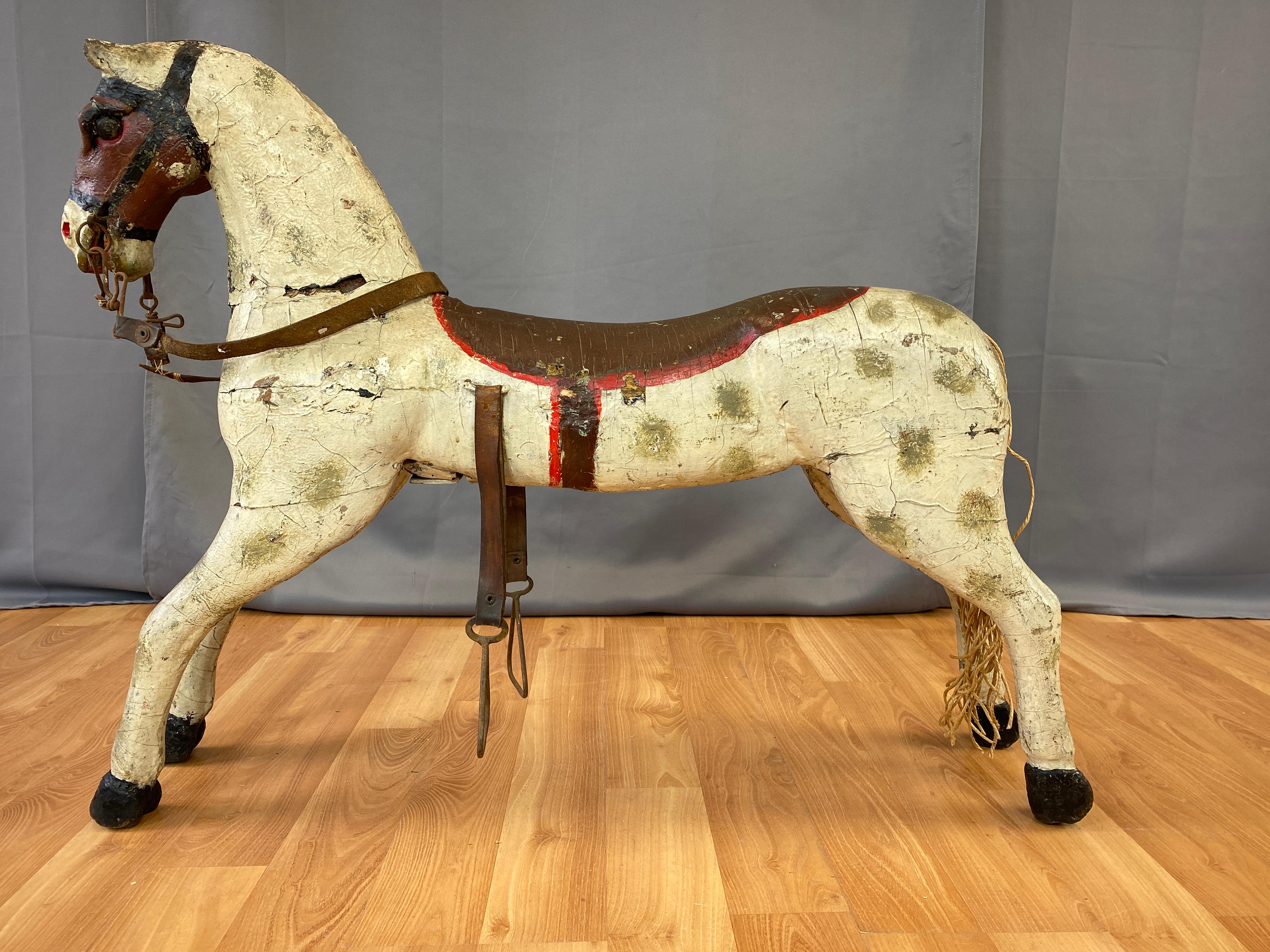 A wonderful whimsical circa 1860s painted wood carousel horse.
Was well made, carved solid wood construction, a testament to whom ever created this horse that it still looks great after all those years going around and around. 
Nice details from