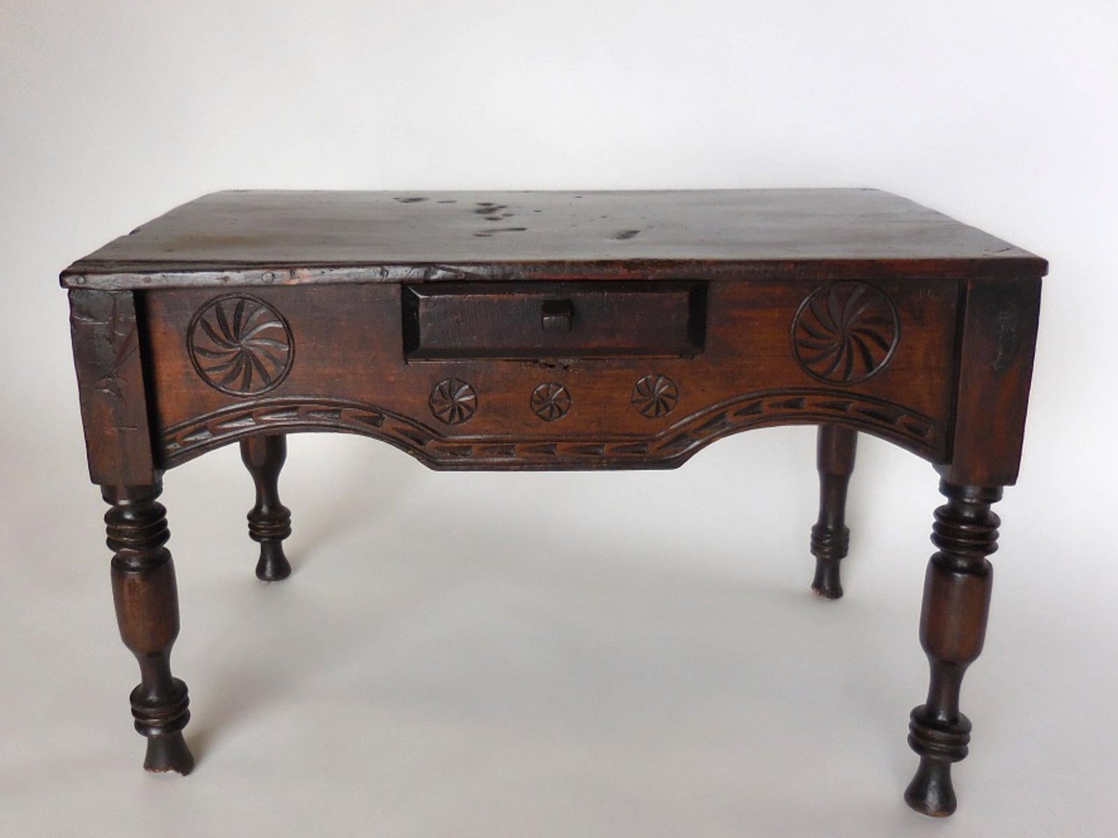 Another beautiful 19th century child's table with carved apron and small drawer. Some wear on legs, mostly at bottom. Lovely naturally age patina throughout piece. Old candle burn marks on the top. All original. Mortise and tenon construction.