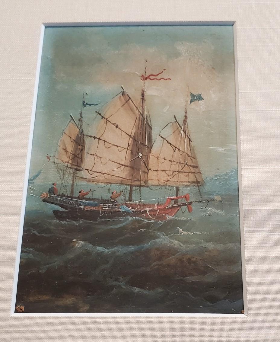 19th Century China trade seascape with a junk, third of three export paintings, circa 1830s, a small finely detailed oil on panel seascape with junk under sail, blue flag flying from fore mast, red swallowtail pennant flying from the main mast, blue