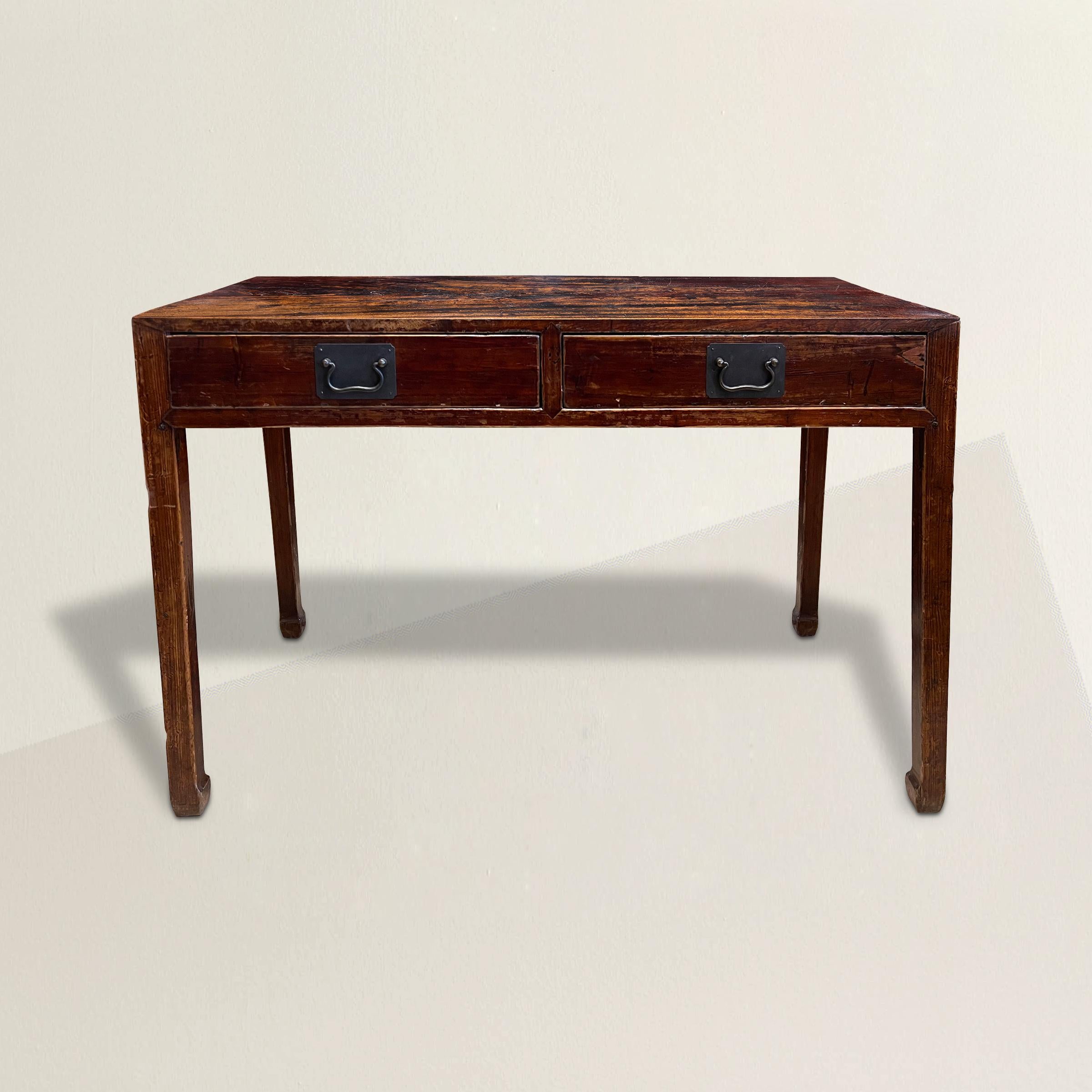 A captivating 19th century Chinese elmwood altar table with two drawers, simple square tapered legs ending in horse-hoof feet, and with a well-worn sangre-de-boeuf lacquer. The perfect console table in your entry, bedroom, or behind the sofa in your