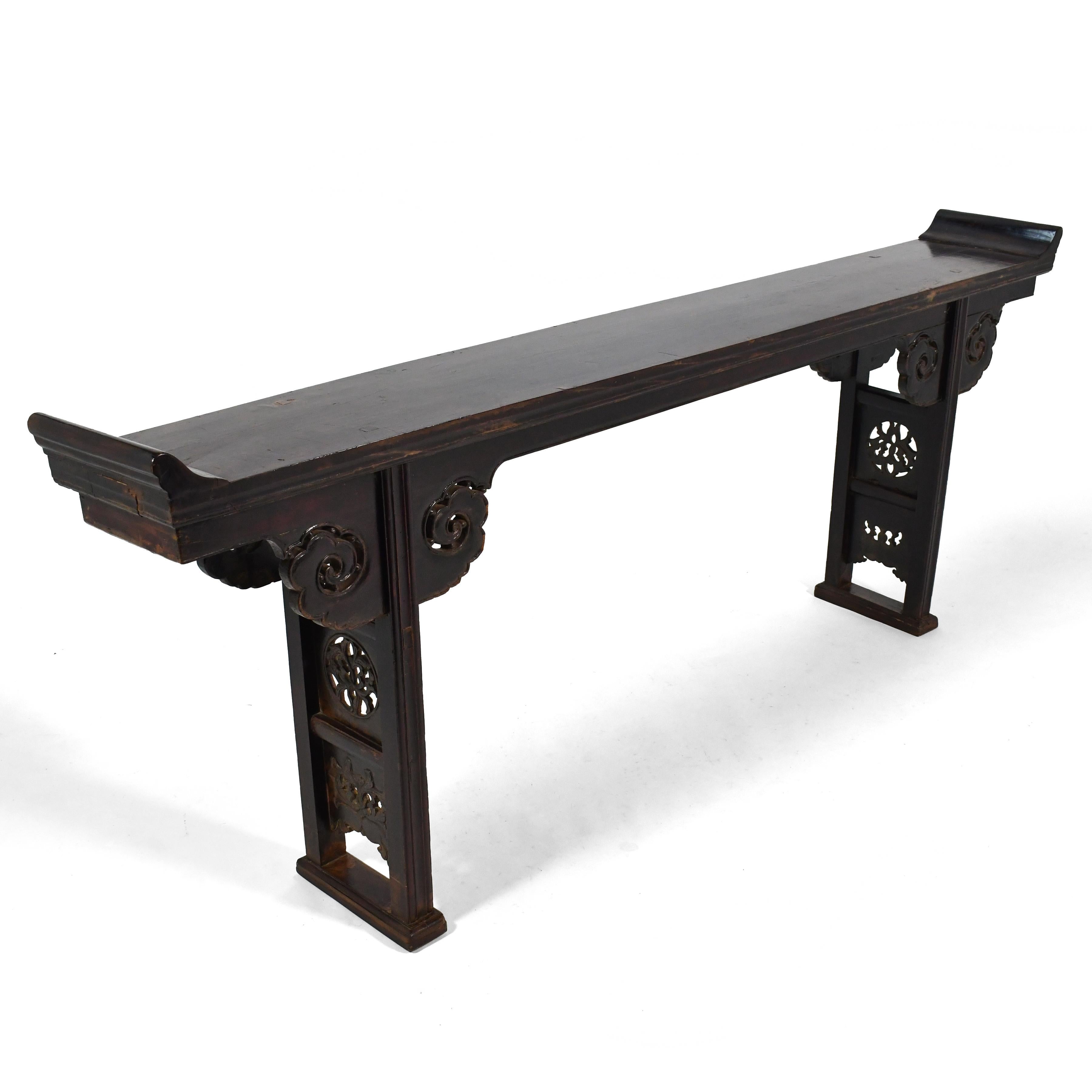This large and strikingly beautiful Chinese alter table almost has more wonderful features than we can list here. It has the perfect amount of decorative carved detail, everted ends, through-tenon and butterfly joinery, and of course, a rich patina