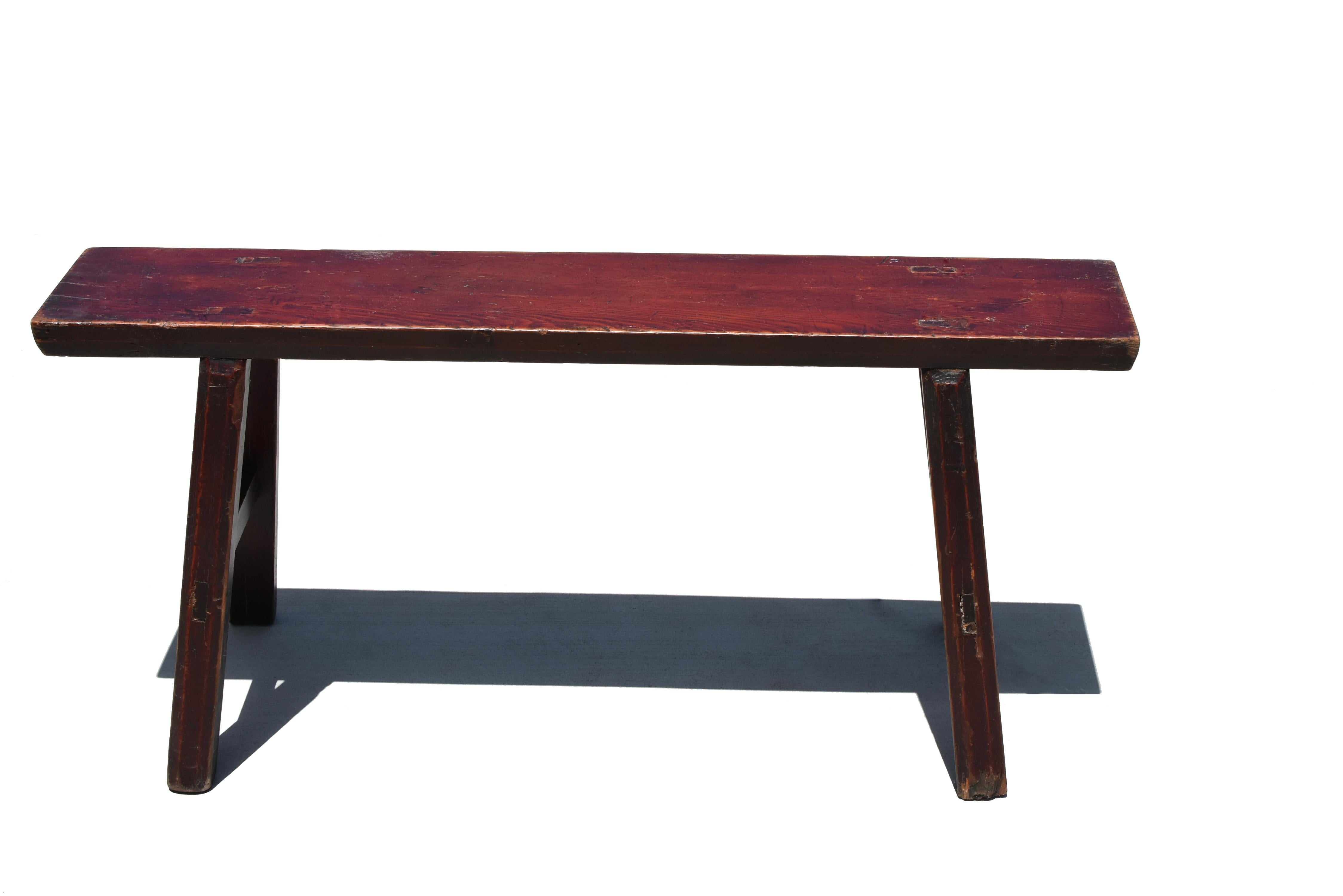 A beautiful solid wood bench with gorgeous wood grain under nice reddish brown finish. The top is made of one single solid board. Solid construction with tenons and mortises ensures stability. A truly functional and versatile piece for all styles of