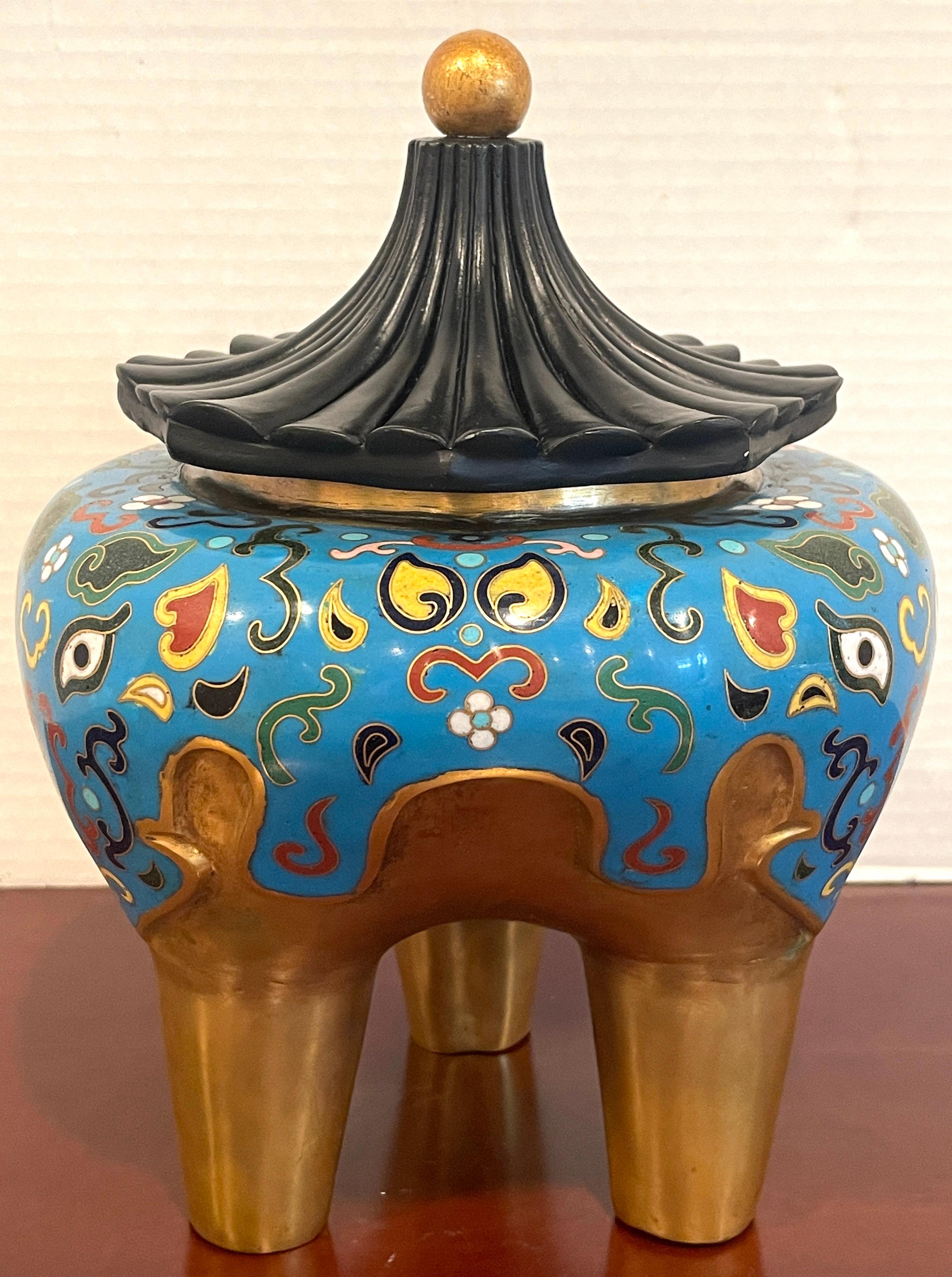 19th century Chinese Archaic style Cloisonné & Lacquer Elephant Motif Censor 
With Associated later lacquer & bronze pagoda lid, resting on a gilt bronze Cloisonné elephant motif three legged censor. Unmarked.
11