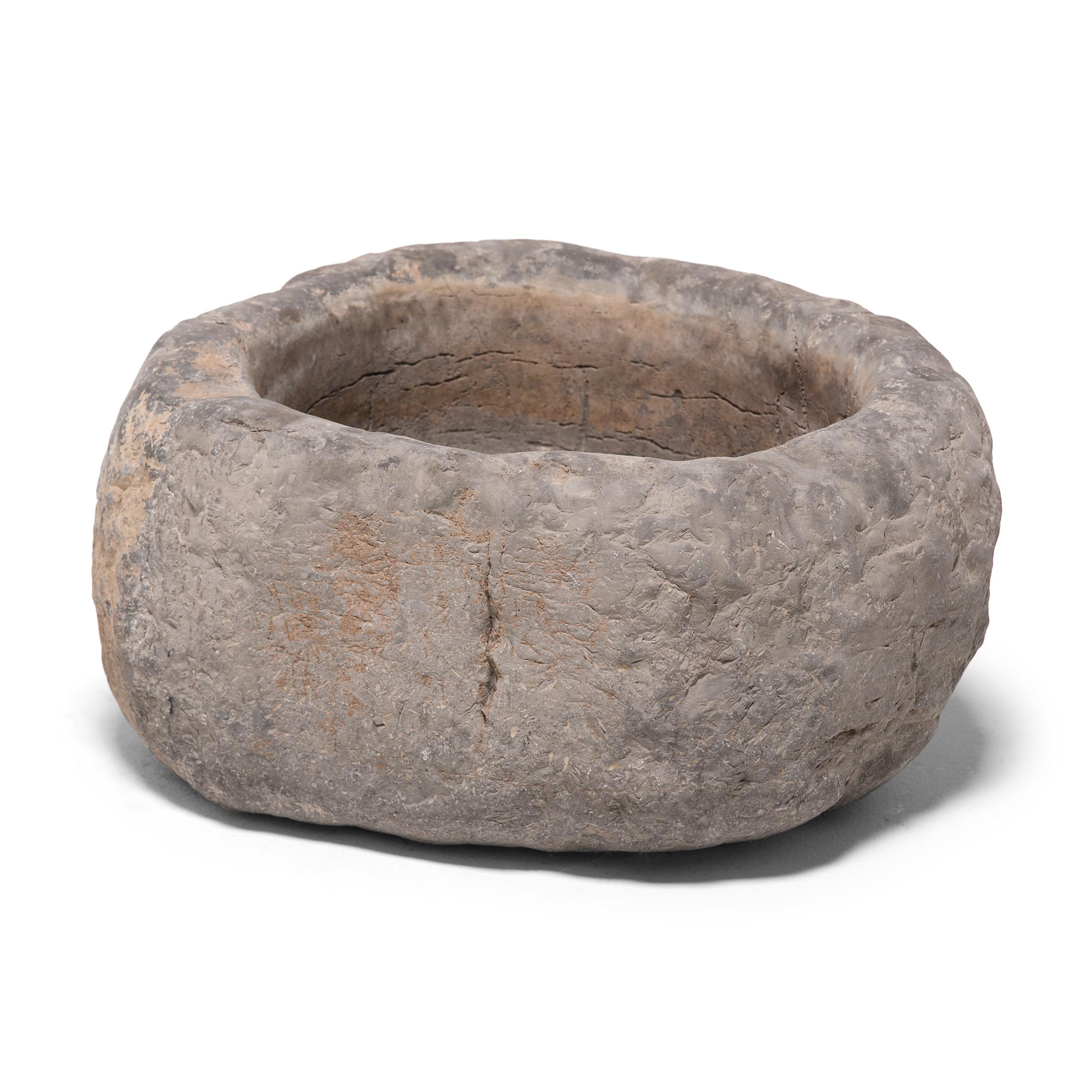 This limestone basin was carved by hand over two centuries ago, and like many Chinese designs, has an elegantly simple form. In China, rock as an element is classified as 